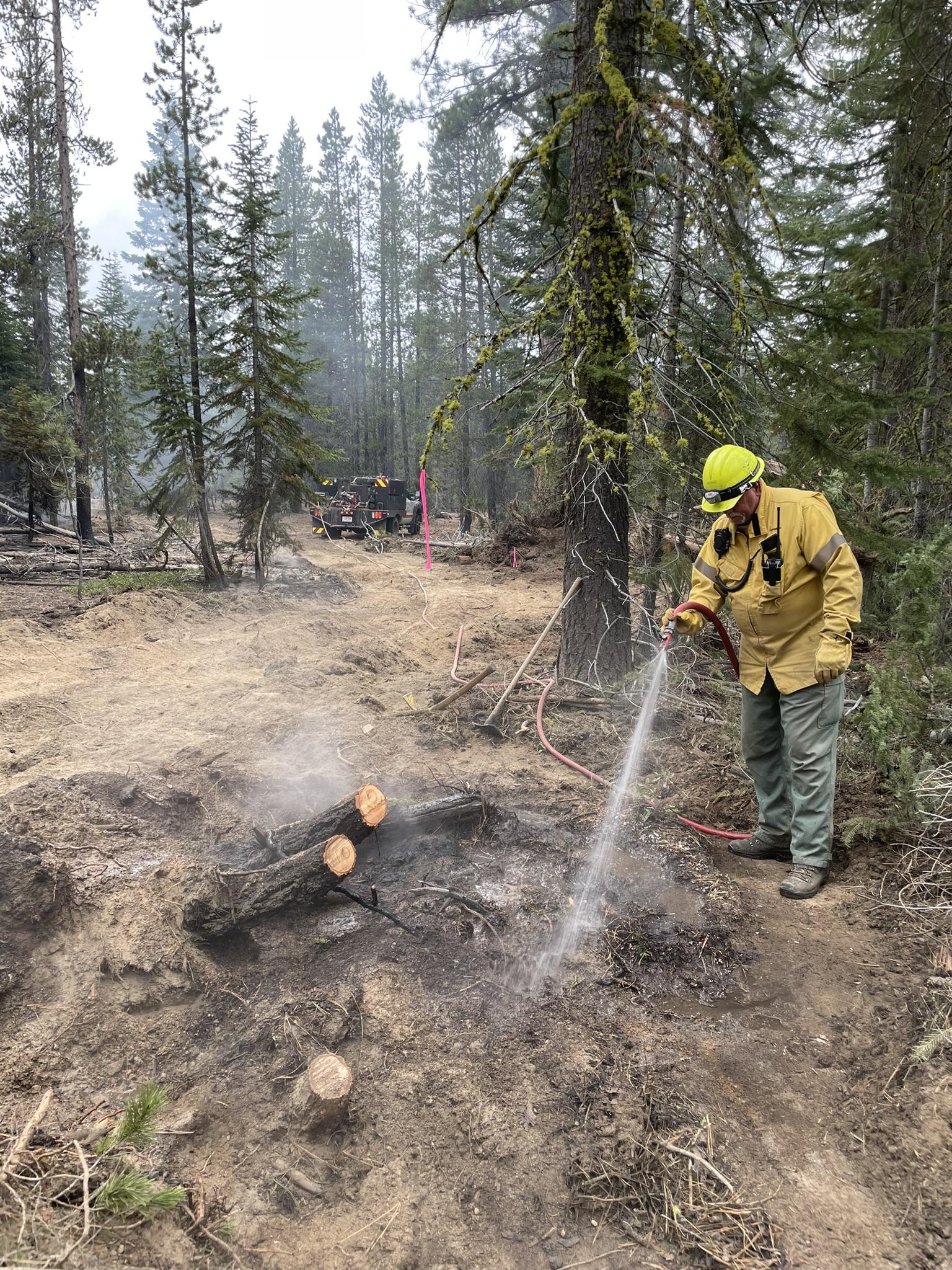 Firefighters extinguishing hot spots.