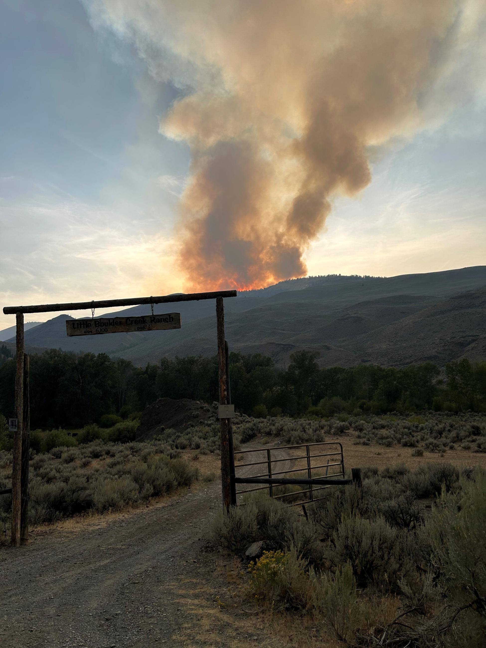 Smoke rising from the sagebrush covered Red Ridge hills 