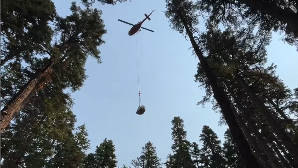 Helicopter lifting a sling load of supplies