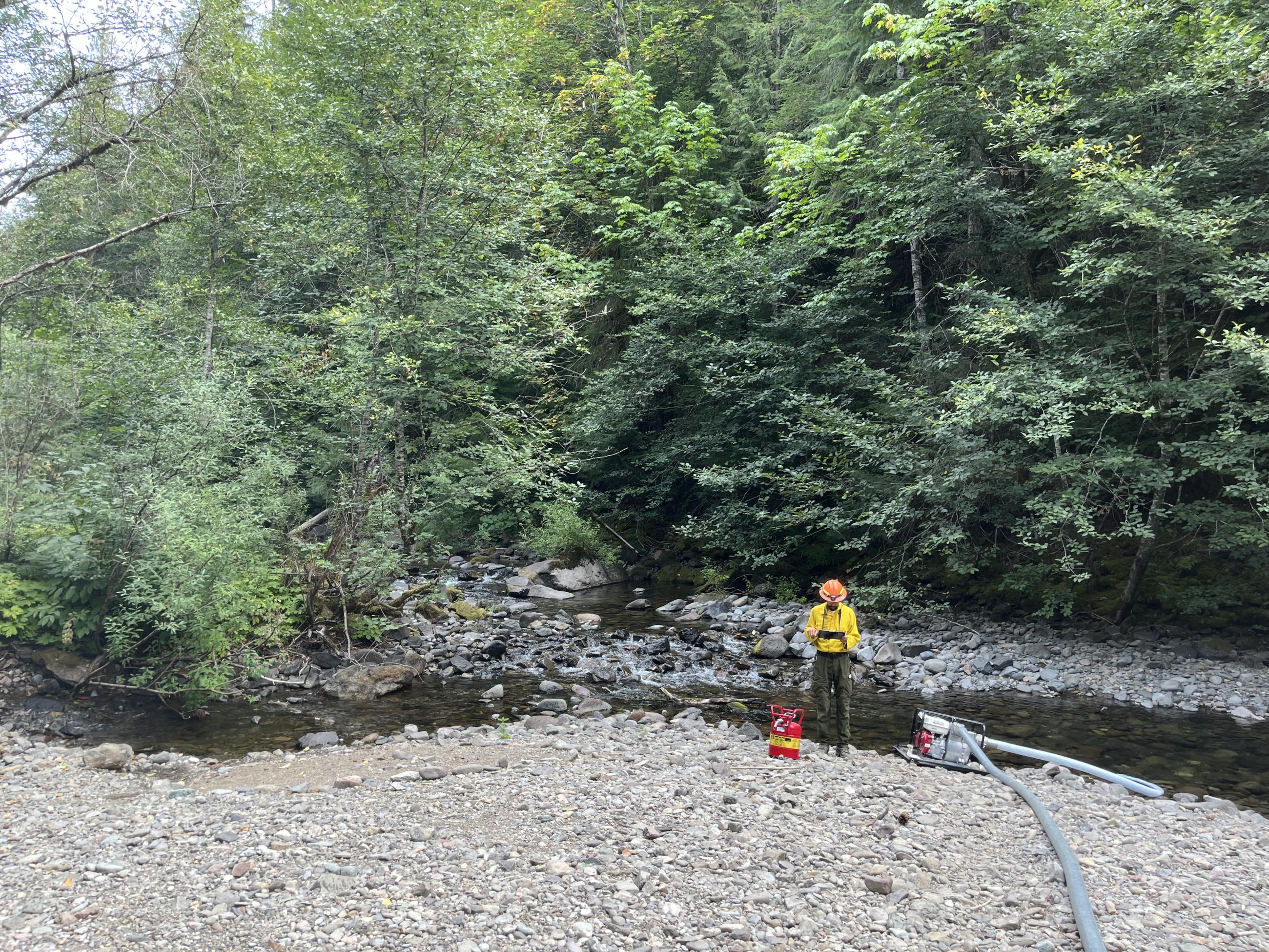 Engineering REAF Hailu Gabriel takes photos and measurements to give directions to repair suppression damage to roads on the Ore Fire.