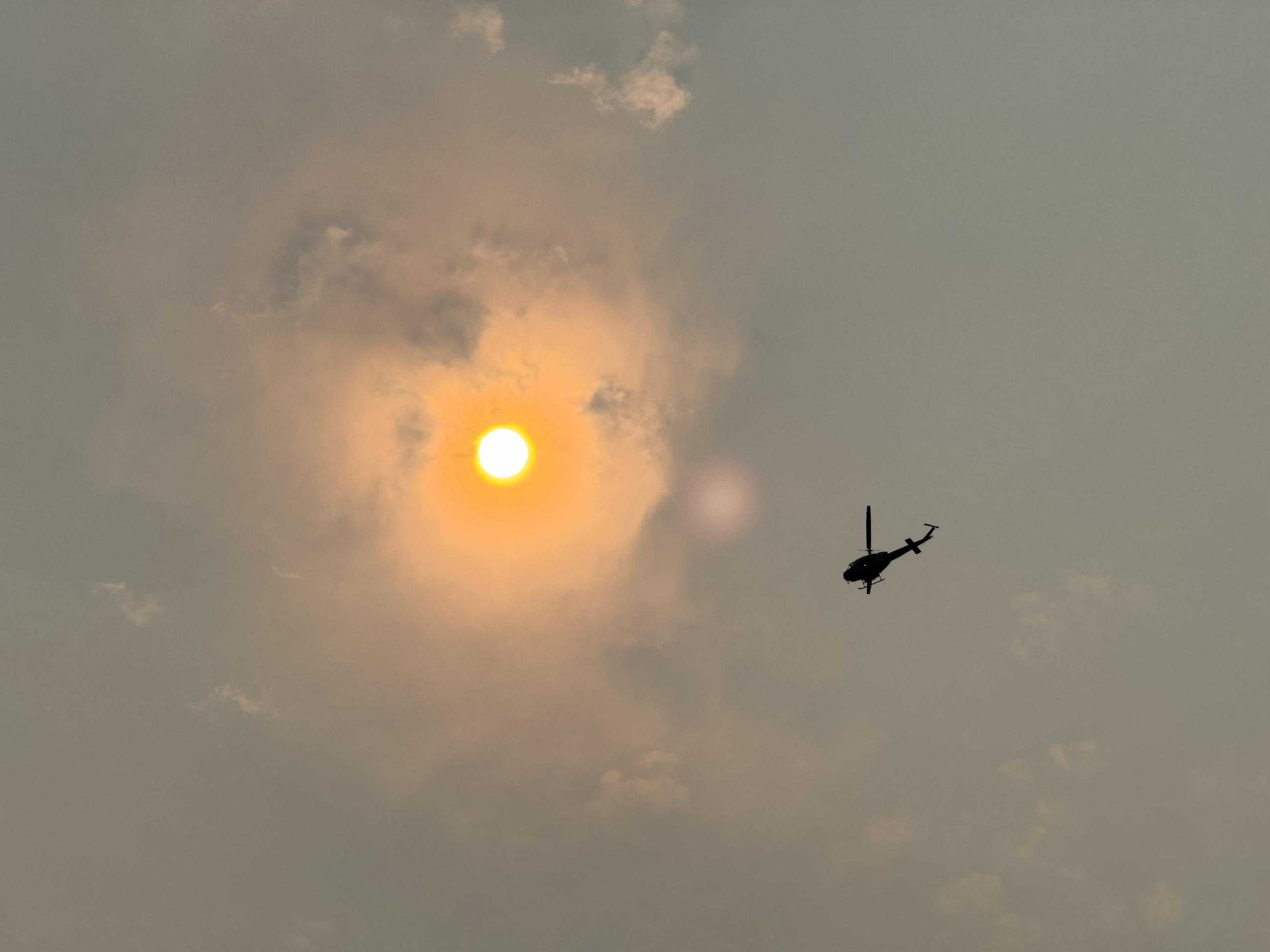 Helicopter flies through smoke