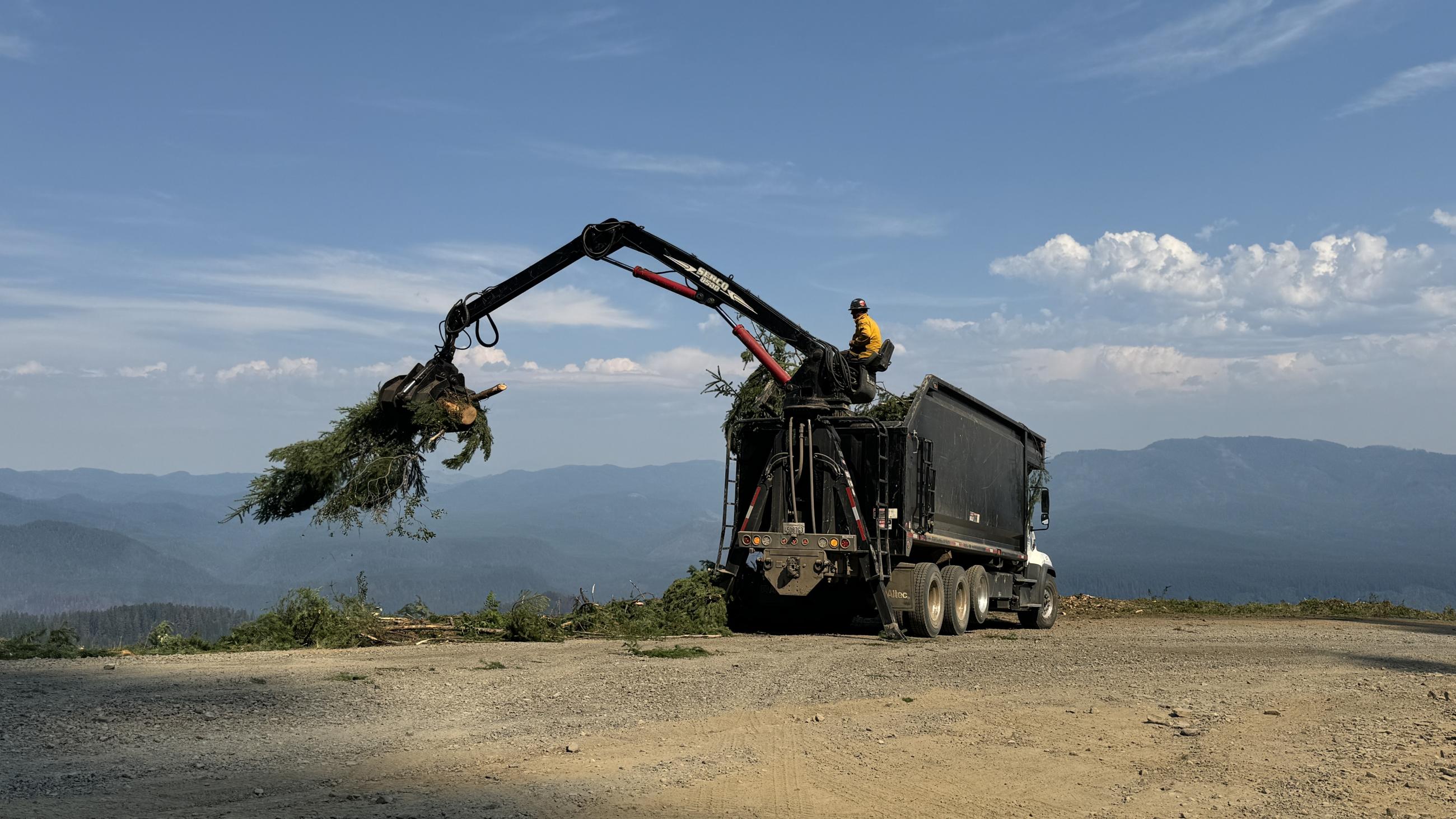 Operator Loading Wood // Chalk Fire September 4th by Jacob Welsh