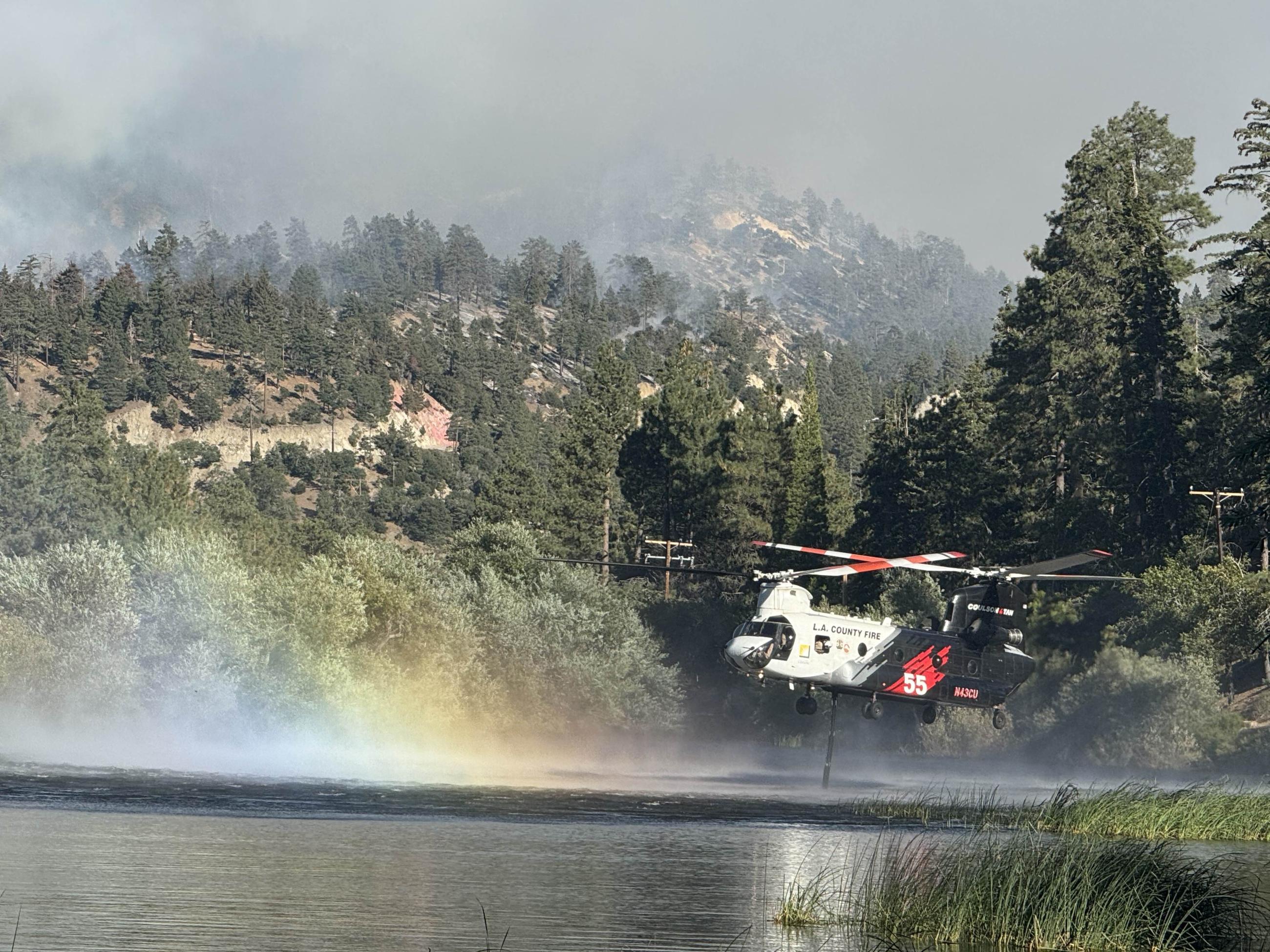 Helitanker scooping water from a lake