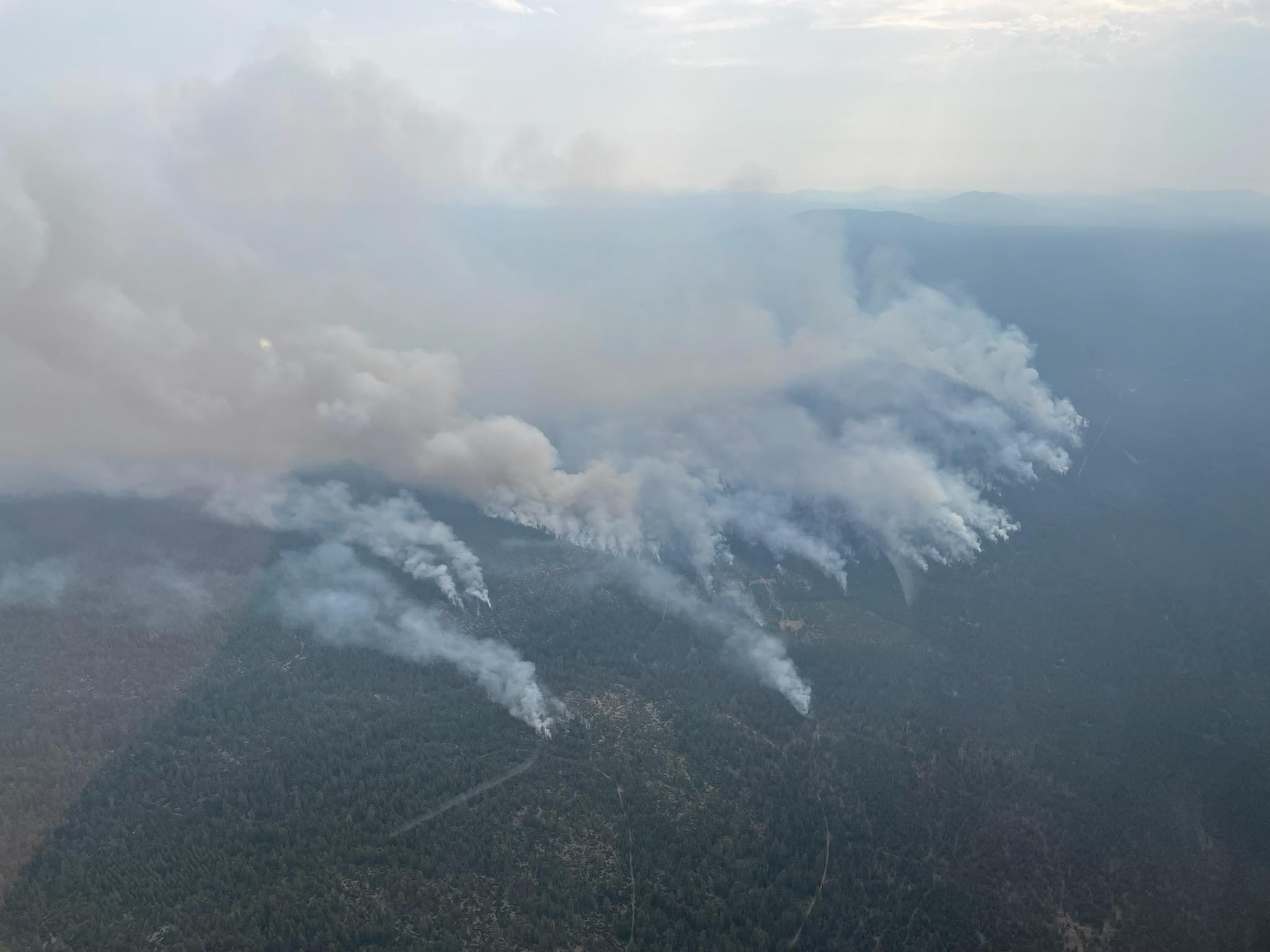 Aerial photograph of smoke rising from a ridgeline on the Firestone Fire.