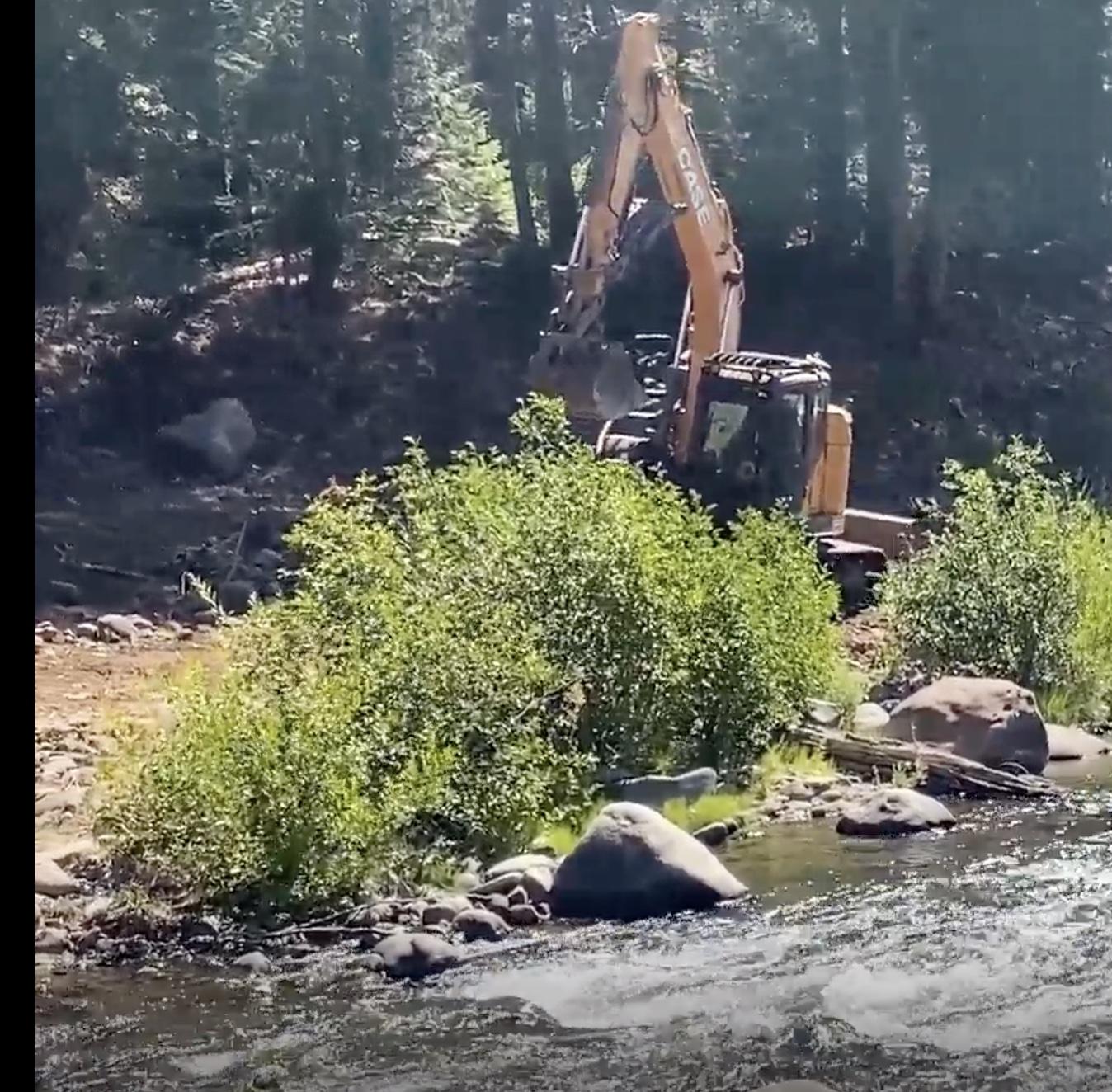 Excavator working to stabilize a riparian area