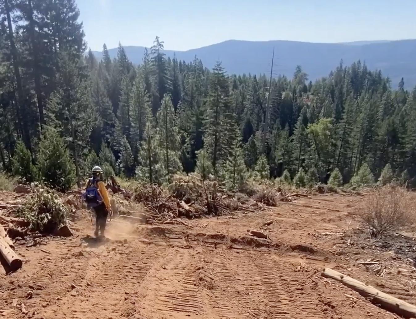 Firefighter reviewing installation of a water bar