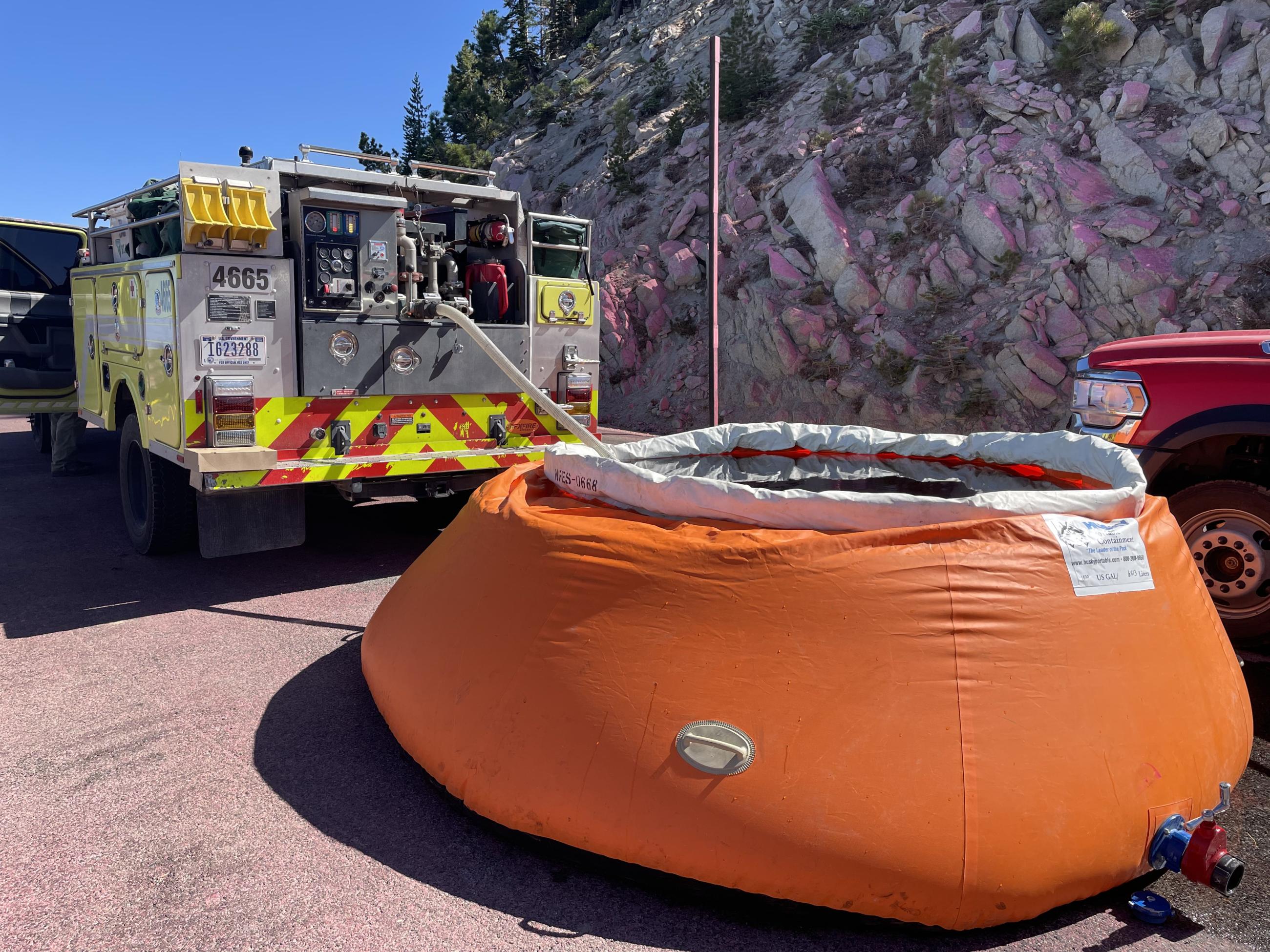 Photo of engine drafting water from a temporary tank called a pumpkin.