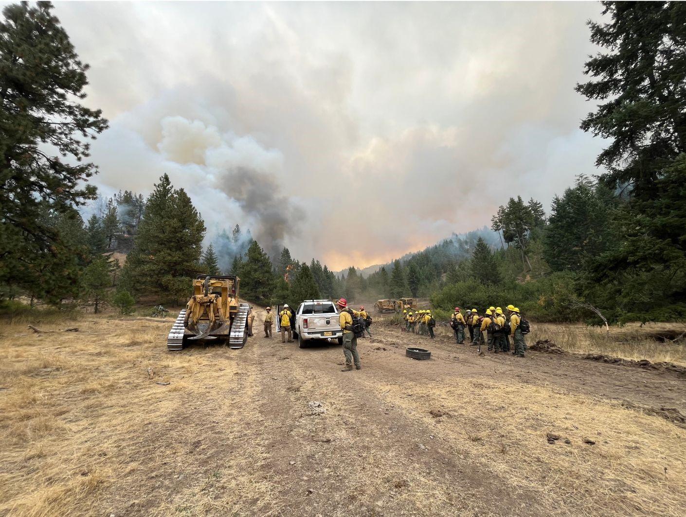 Firefighters congregate near the Service Fire on Sept. 7