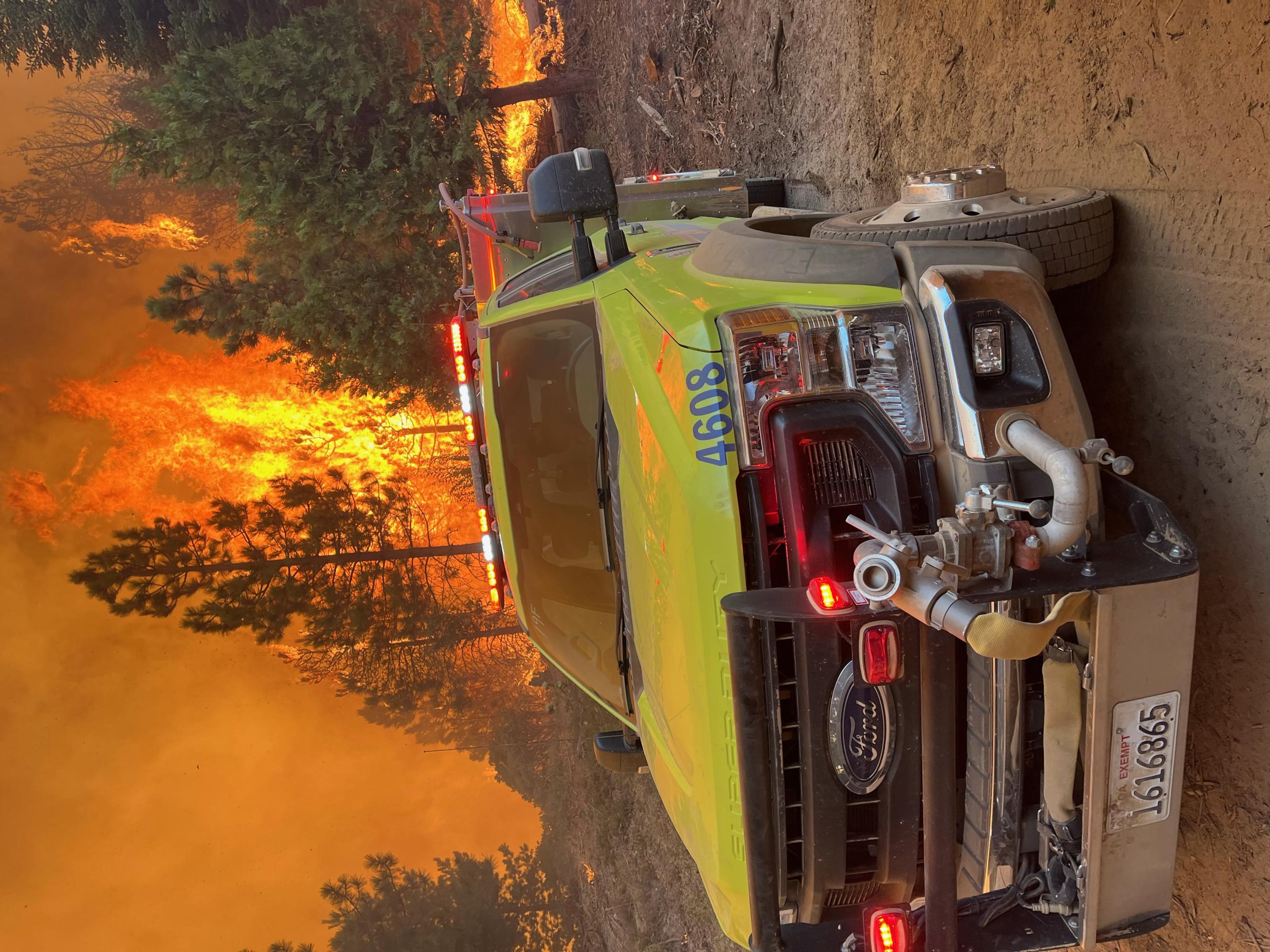 A firetruck with fire behind it