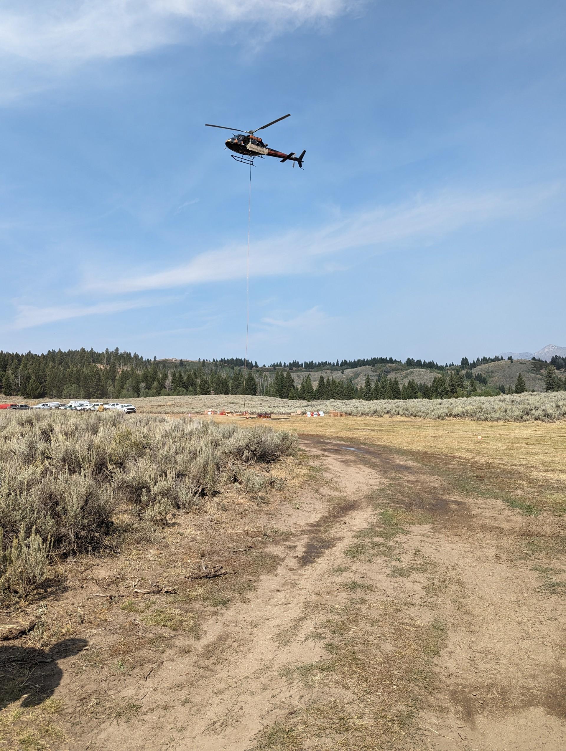 Helicopter hovering about the ground on a communications repeater mission on the Chimney Fire