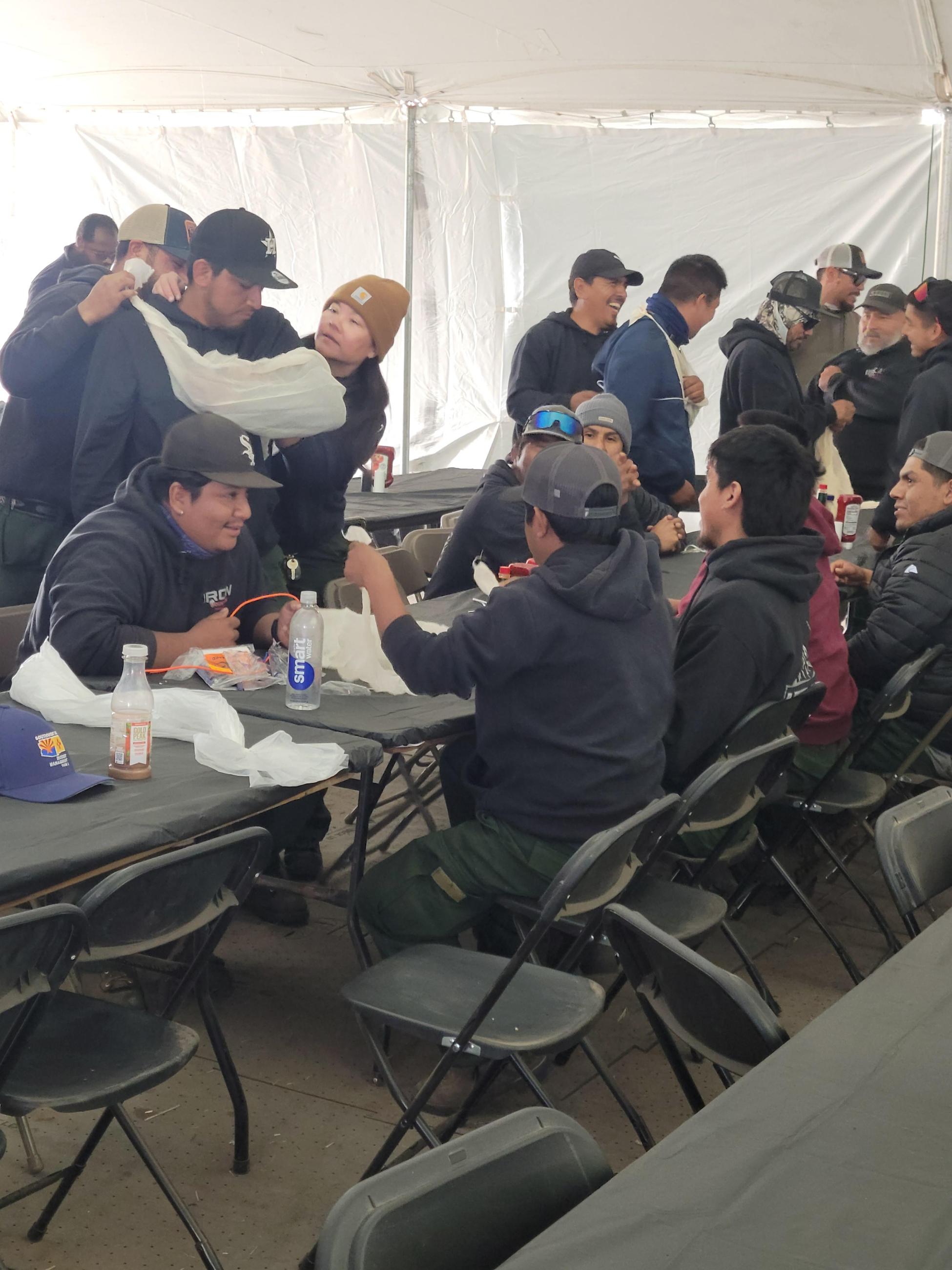 Picture of medical training with firefighters practicing how to apply a tourniquet.