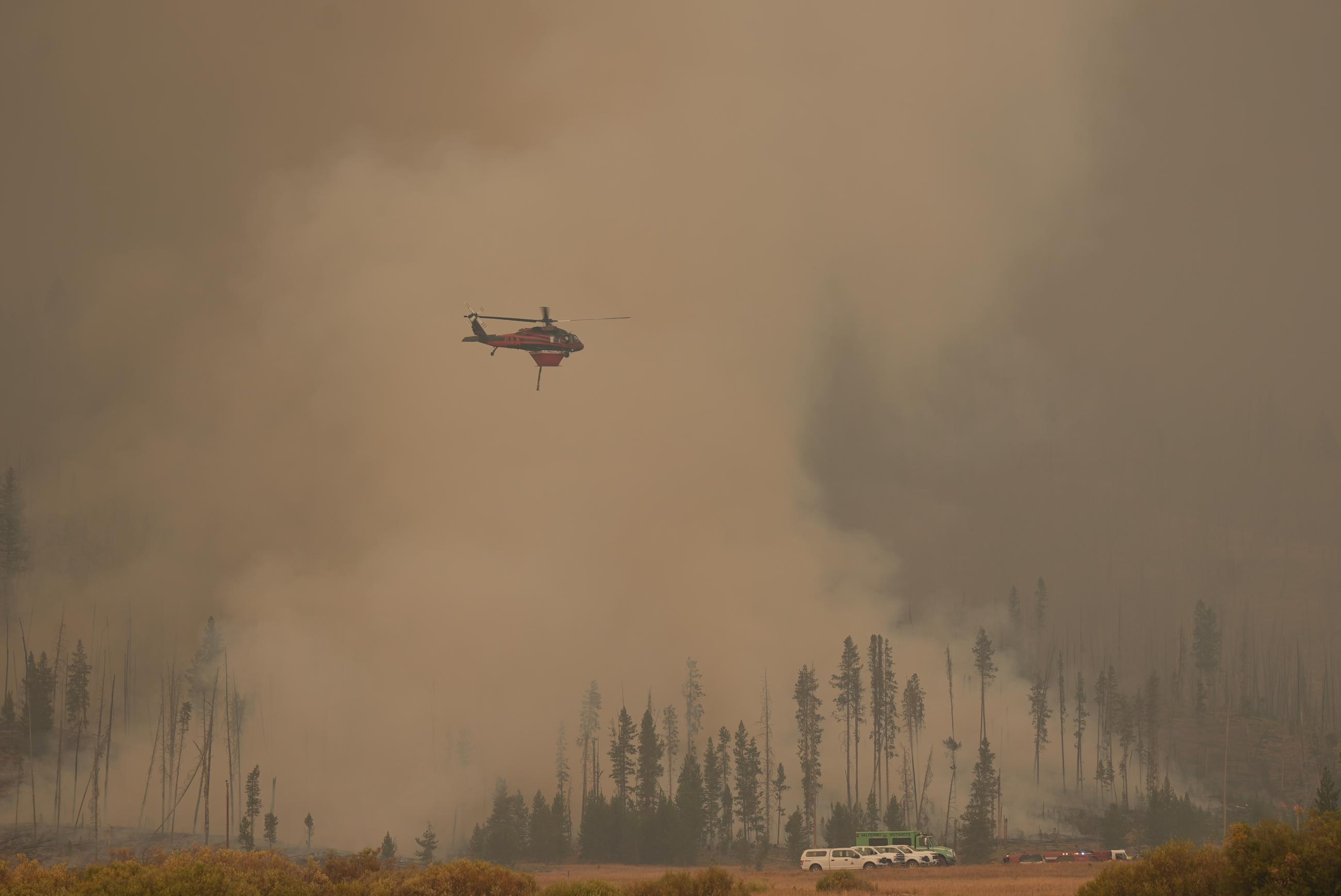 photo showing air tanker over spot fire