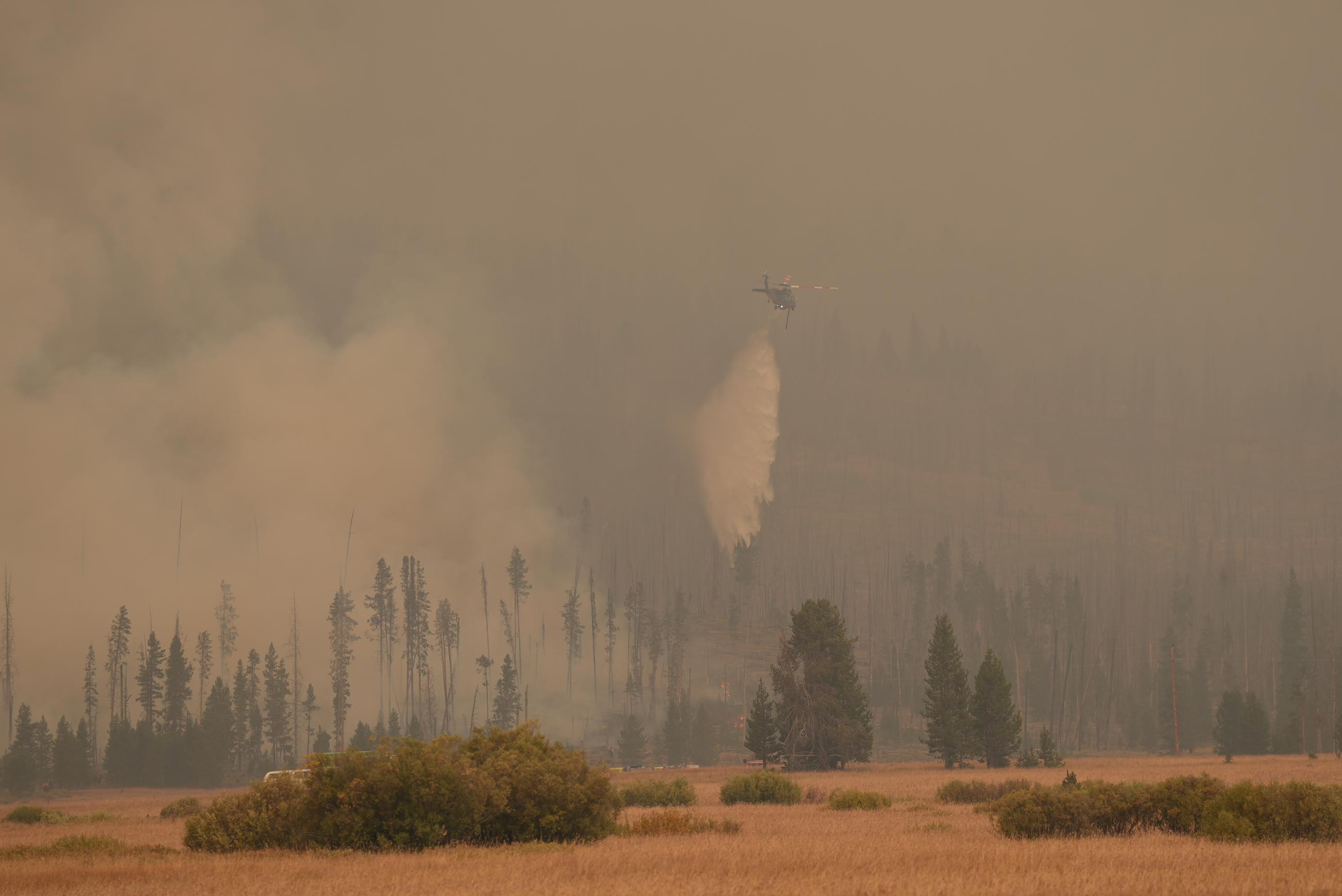 photo showing water being dropped on spot fire