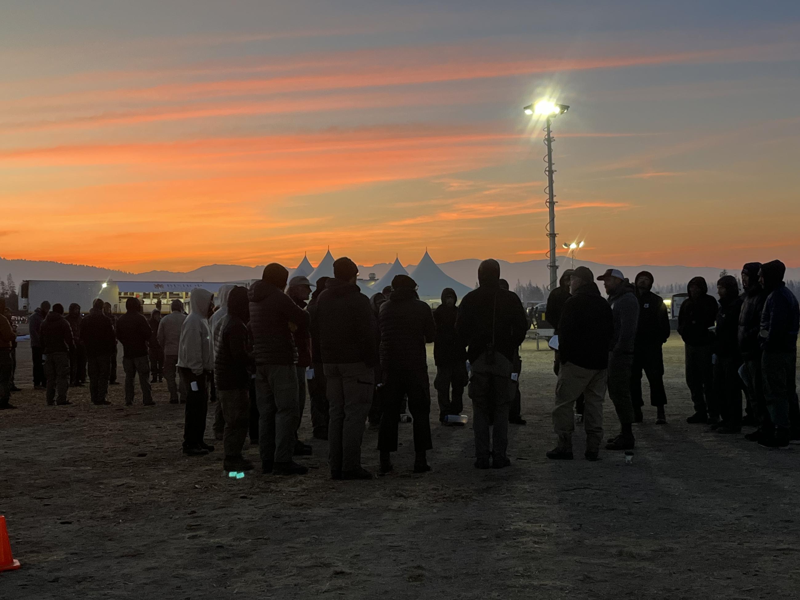 early morning photo of crews gathered around