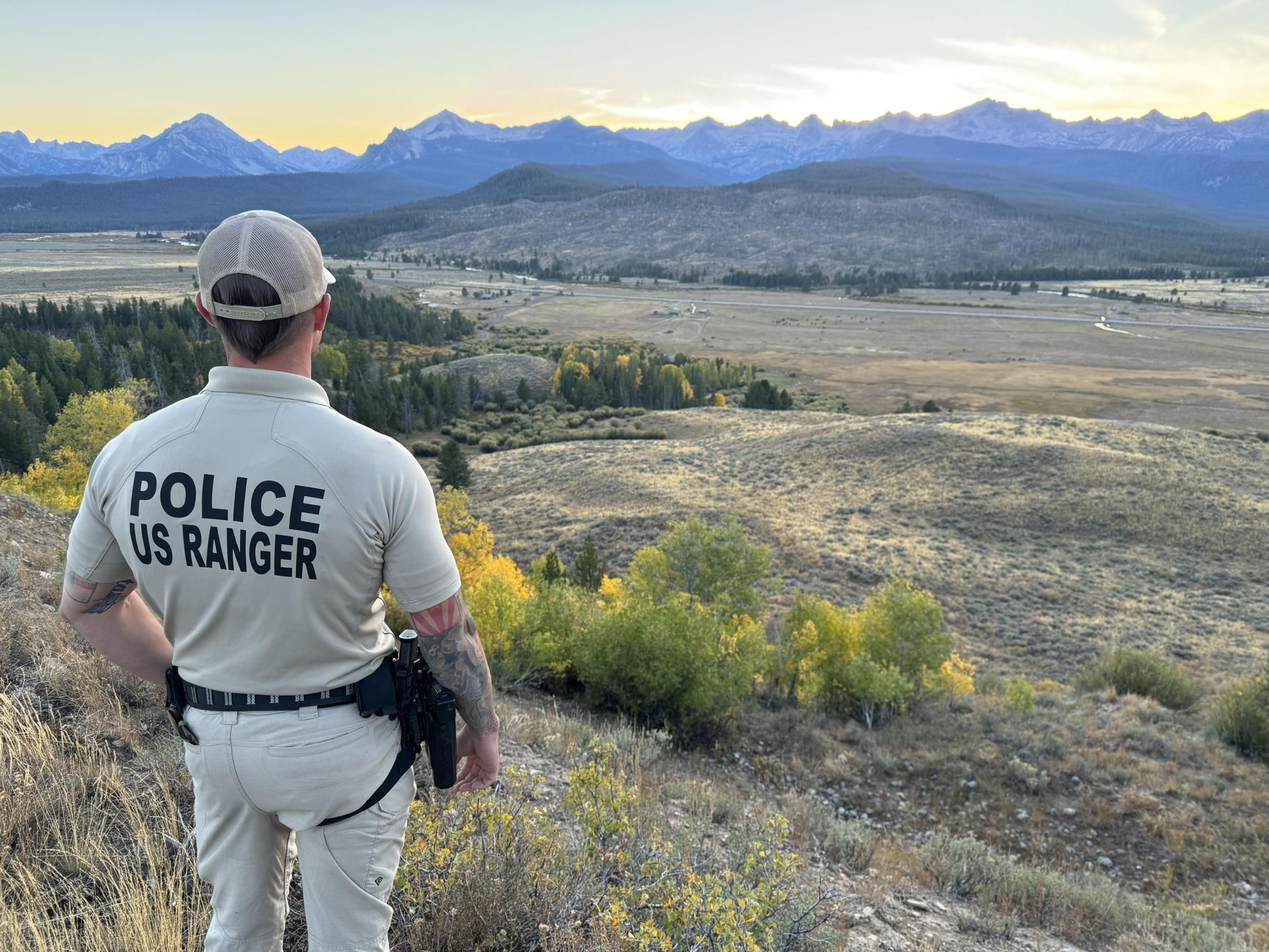 Law enforcement officer looking at the Sawtooths, 9/21/24