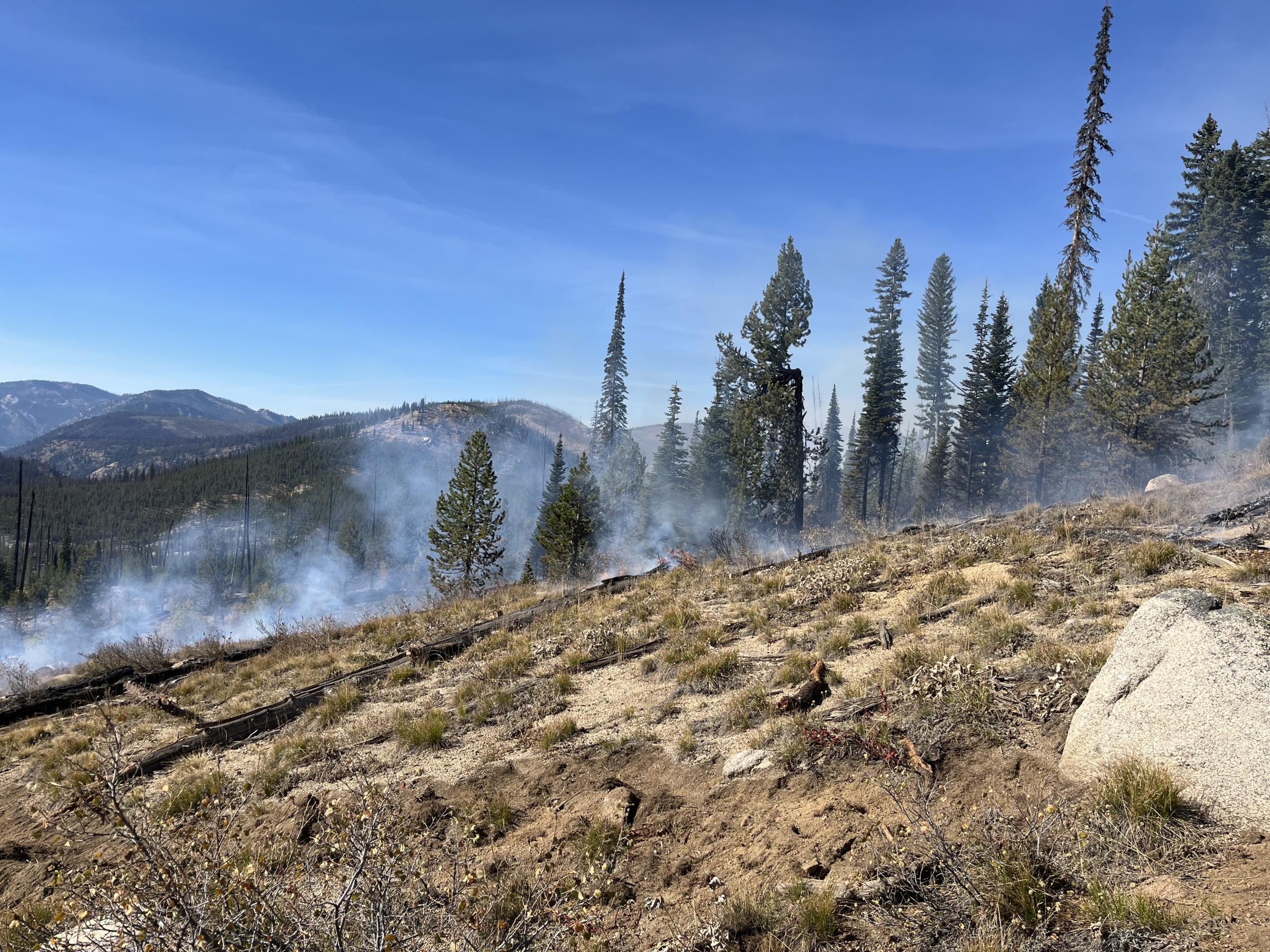 hillside with a small amount of smoke