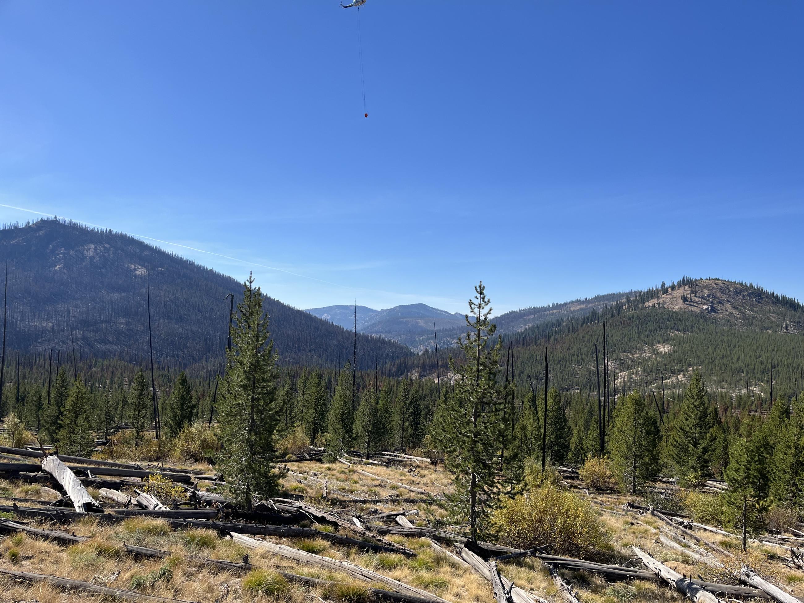 landscape view with a helicopter working