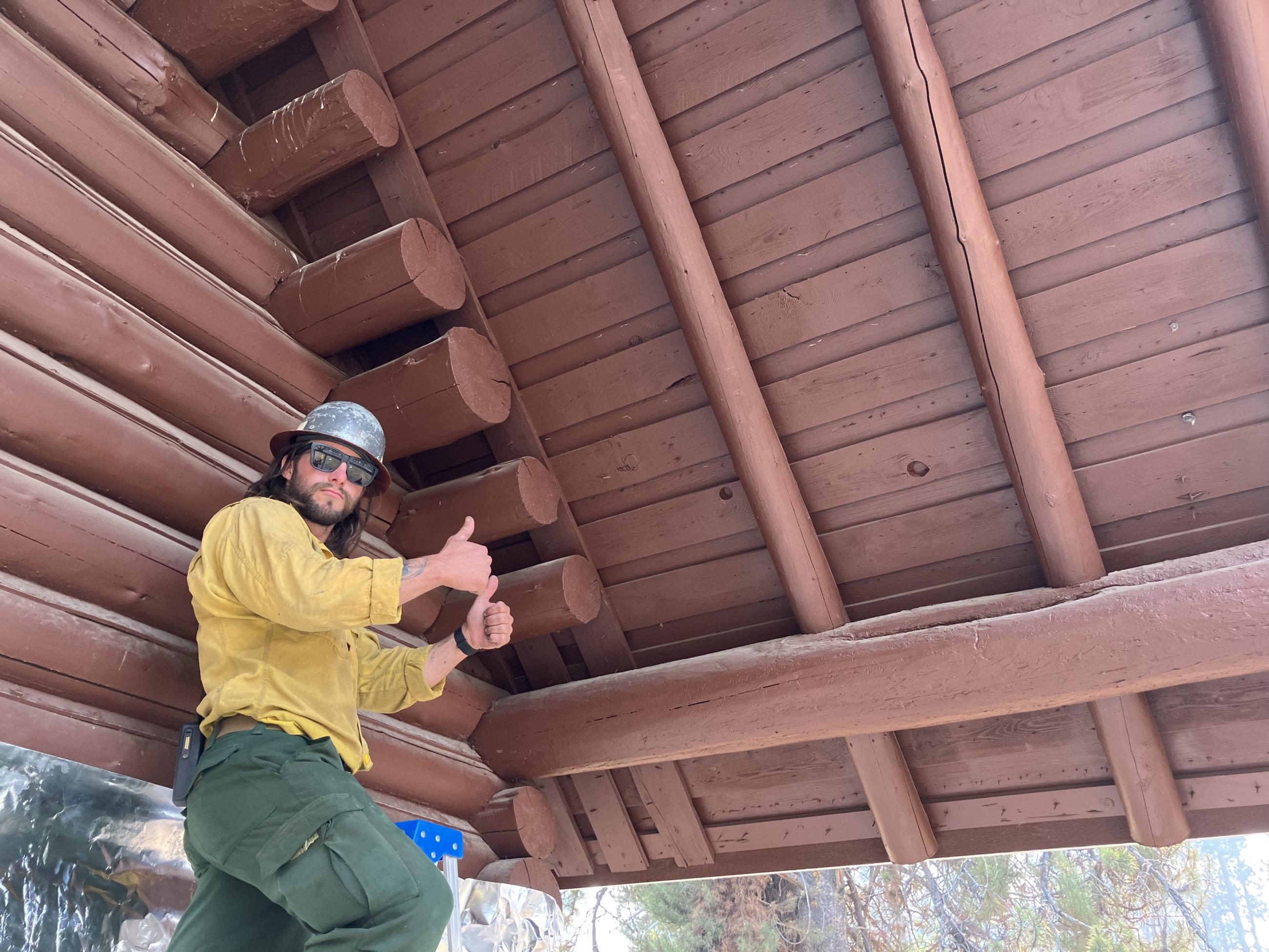 Image showing a Firefighter Begin Wrapping Stolle Meadows Historic Structure with Foil