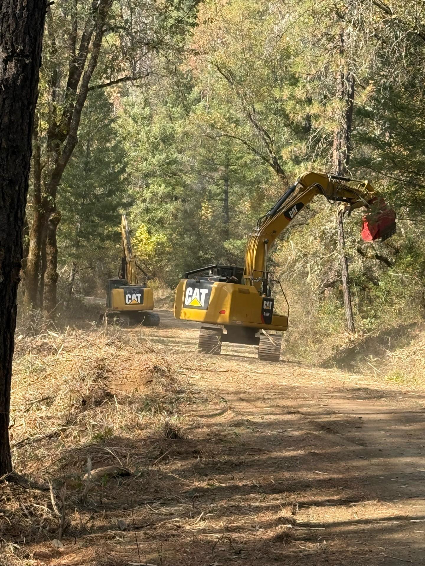 An excavator performing fire suppression repair