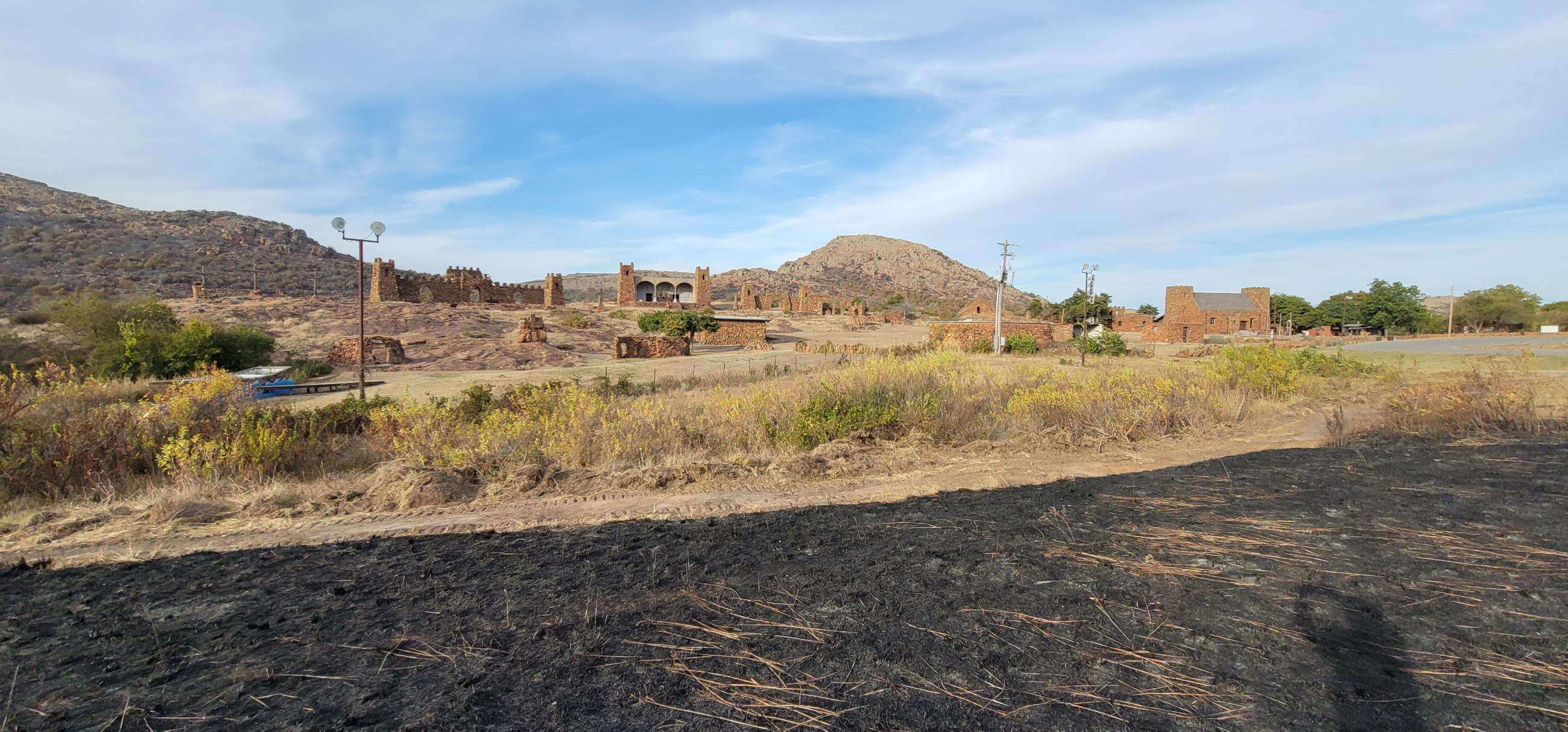 Rush Fire burn (black area in foreground) at fireline placed to protect Holy City structures