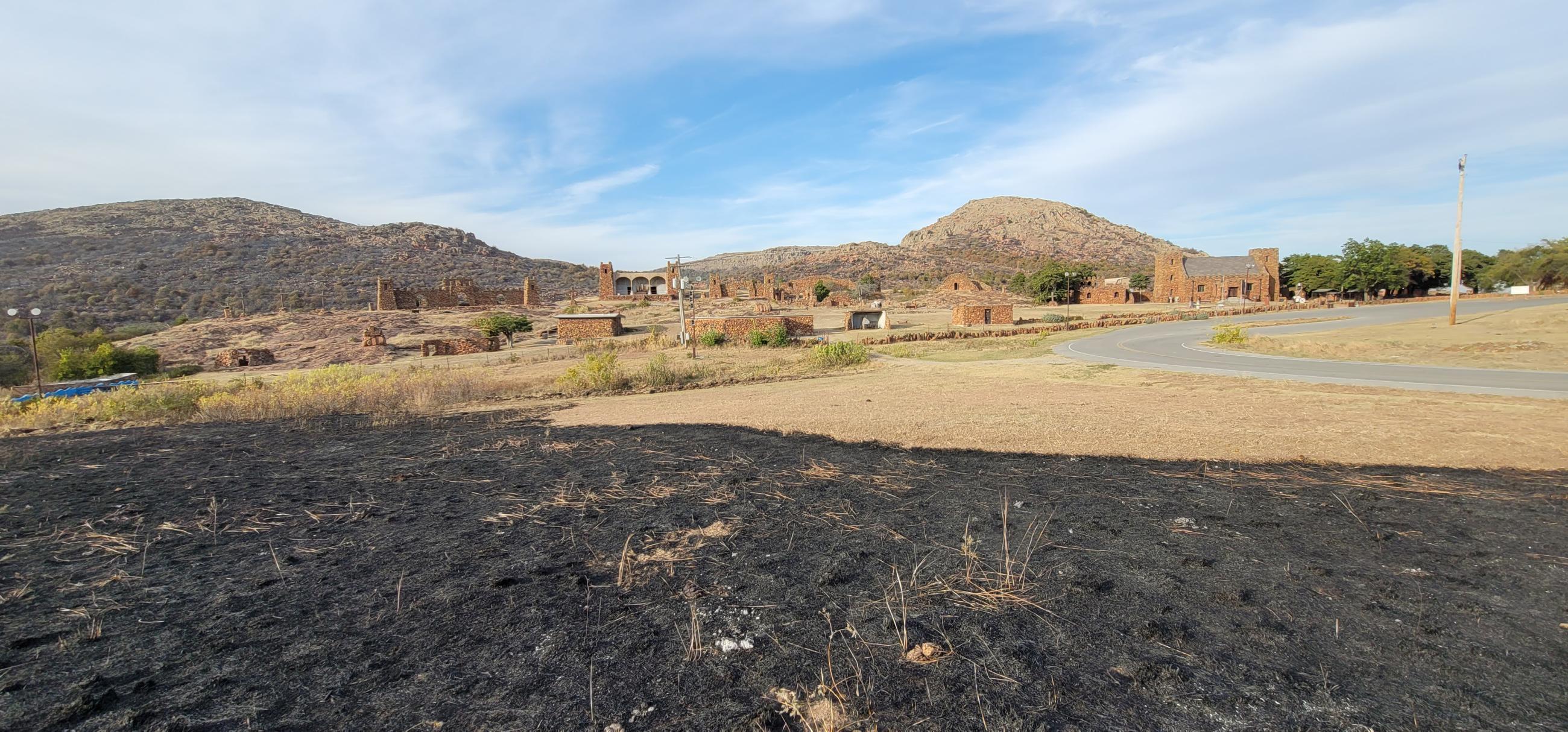 Rush Fire burn (black area in foreground) at fireline placed to protect Holy City structures