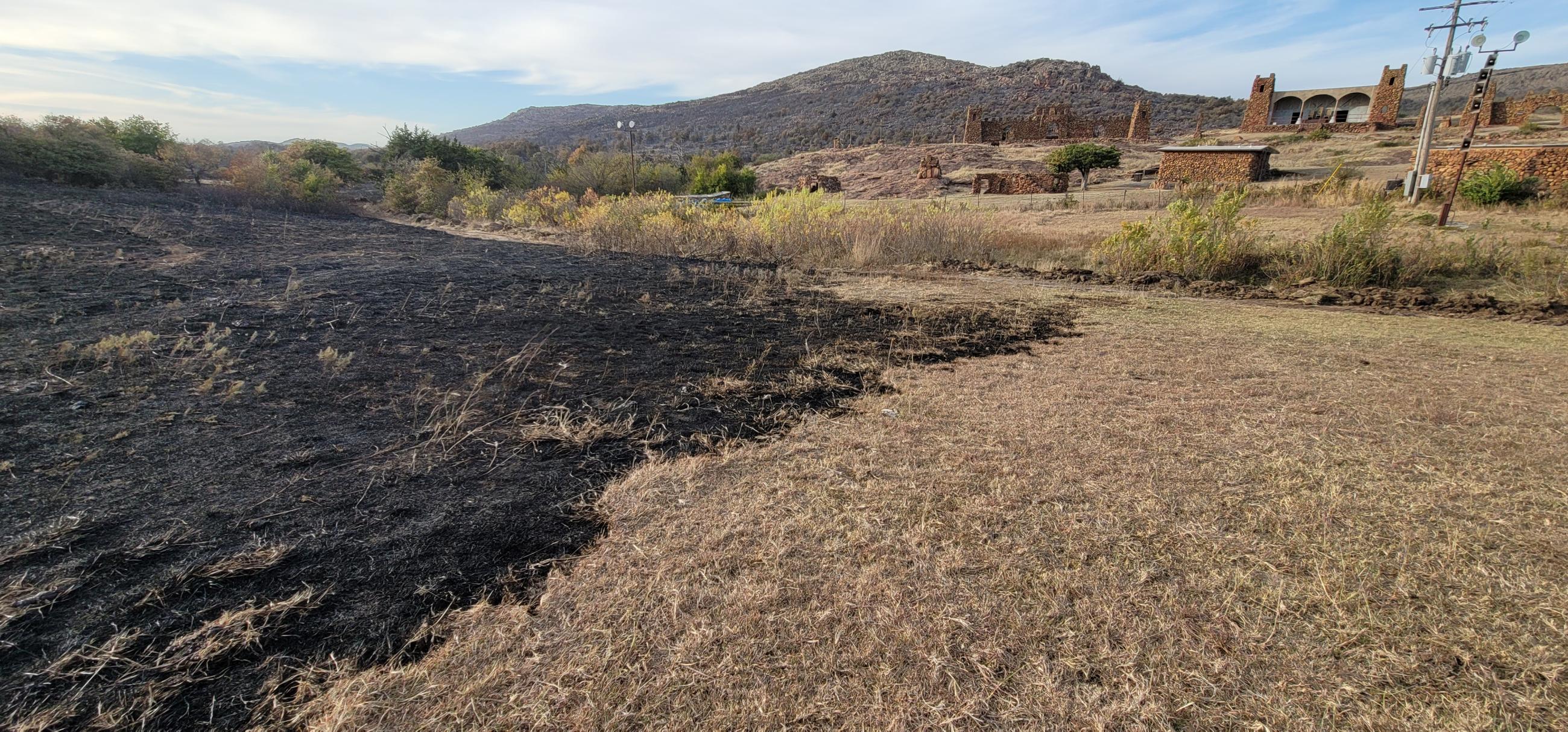 Rush Fire burn (black area in foreground) at fireline placed to protect Holy City structures