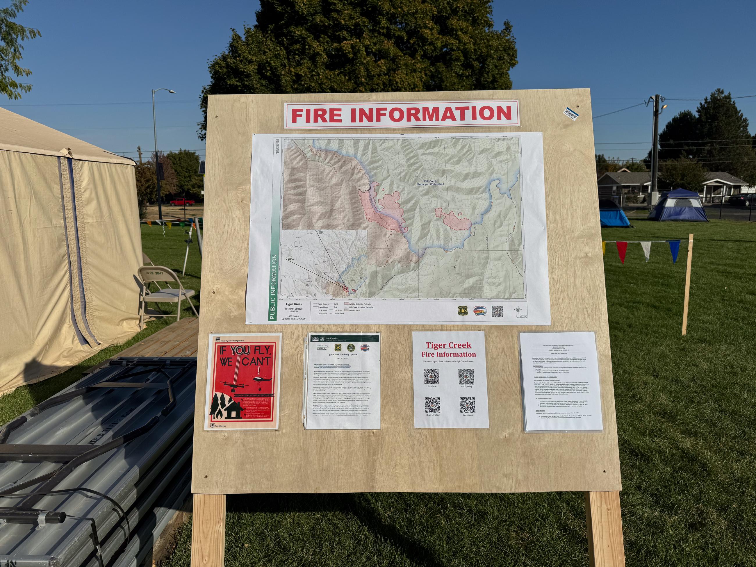 map and information signs on plywood sandwich board