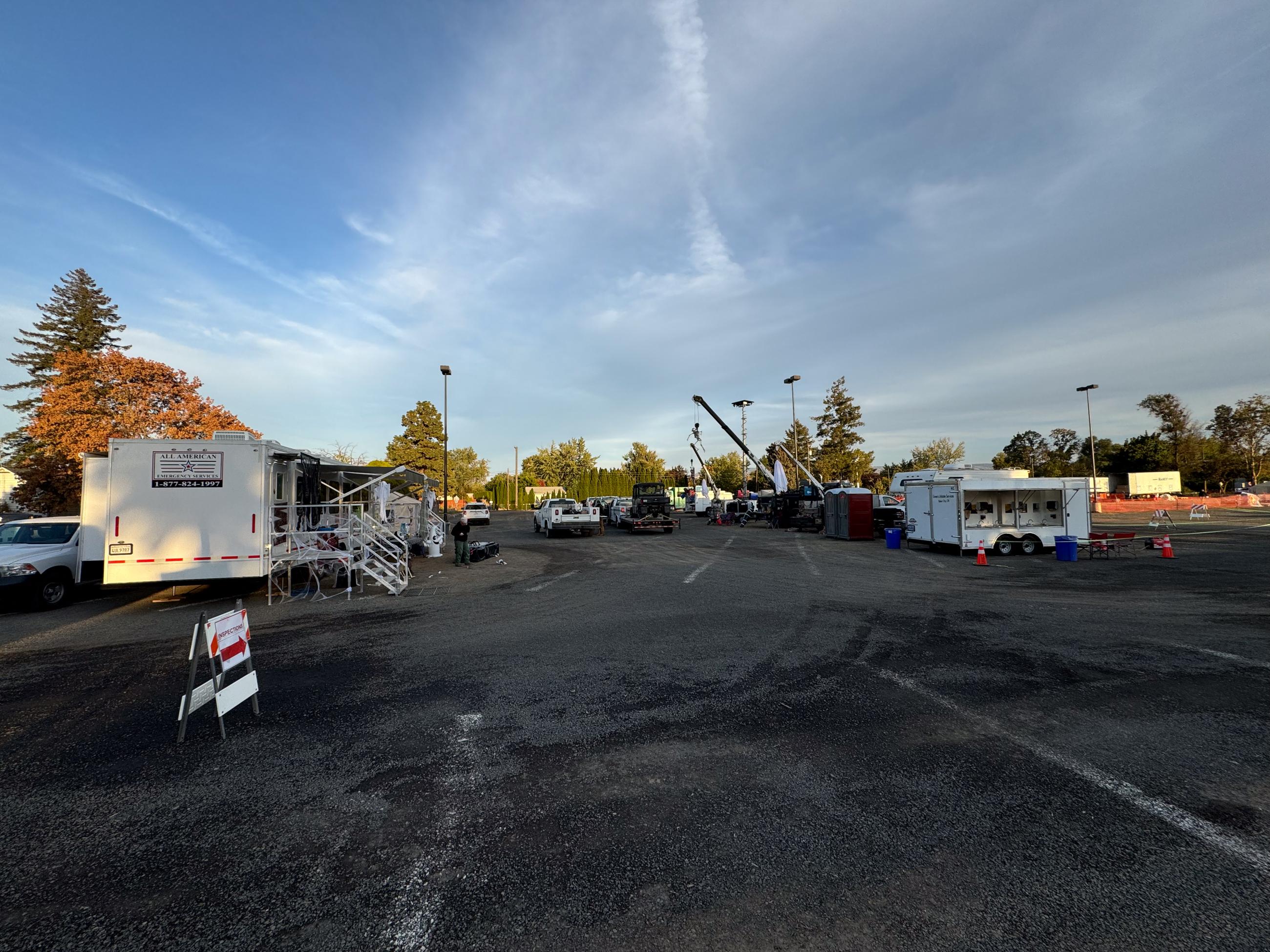 Halloween decorations hanging from trailers with large cloudy sky in background