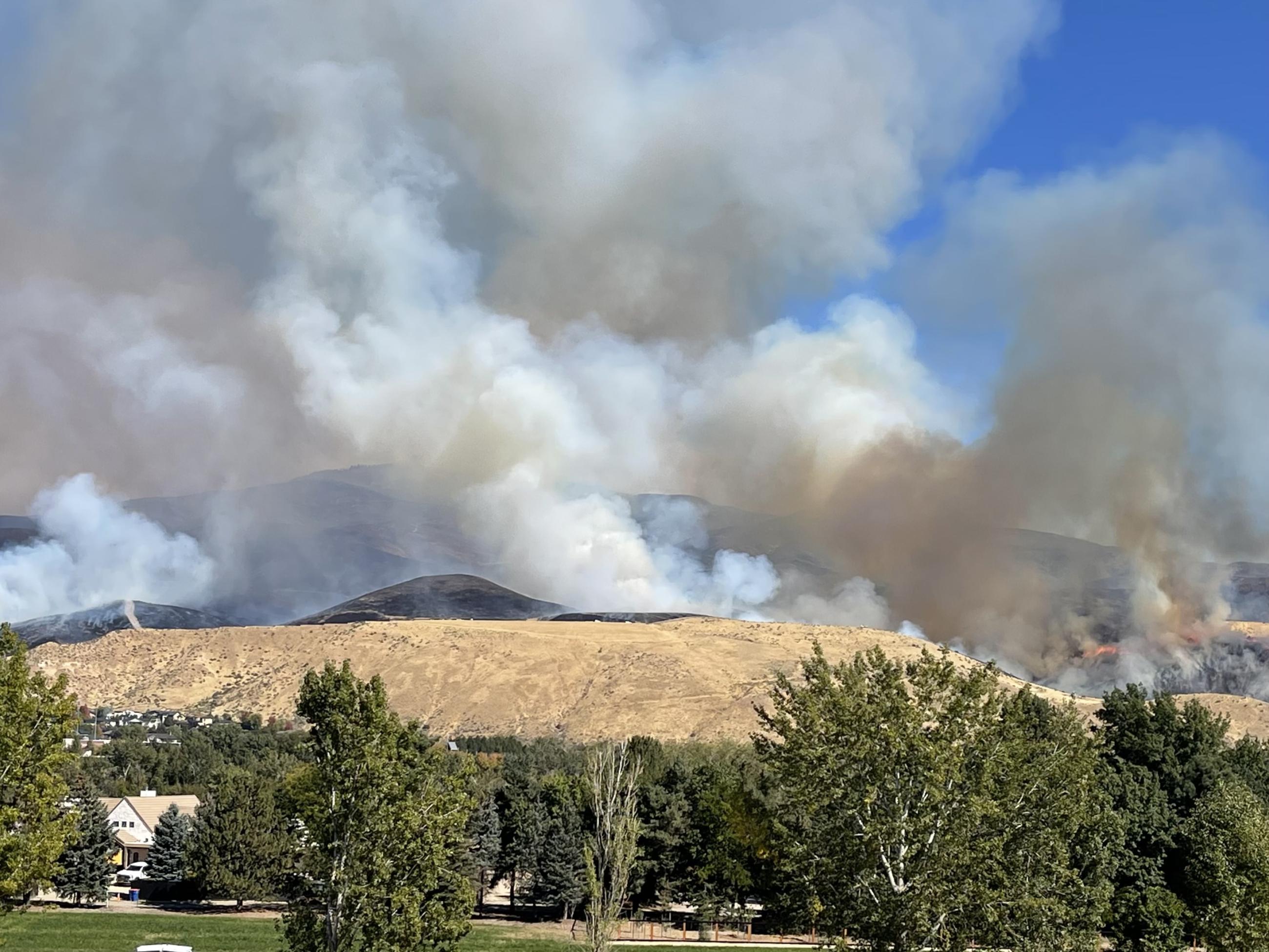 Valley Fire in Boise Foothills producing heavy smoke with blue sky