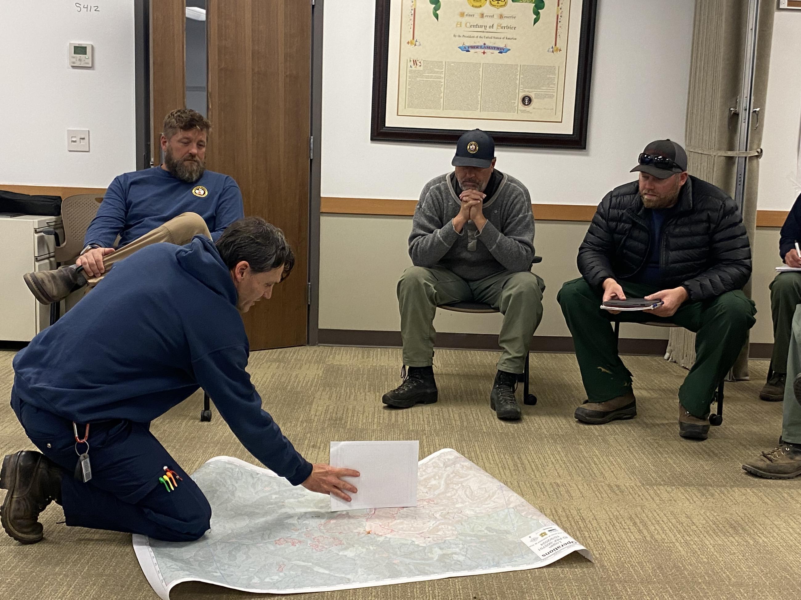 Planning Operations providing an operational update to the command staff.