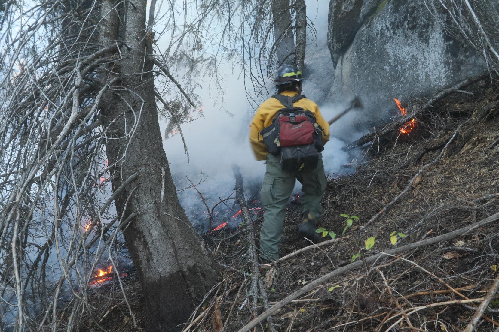 Firefighter Scrapes Around Hot Spot