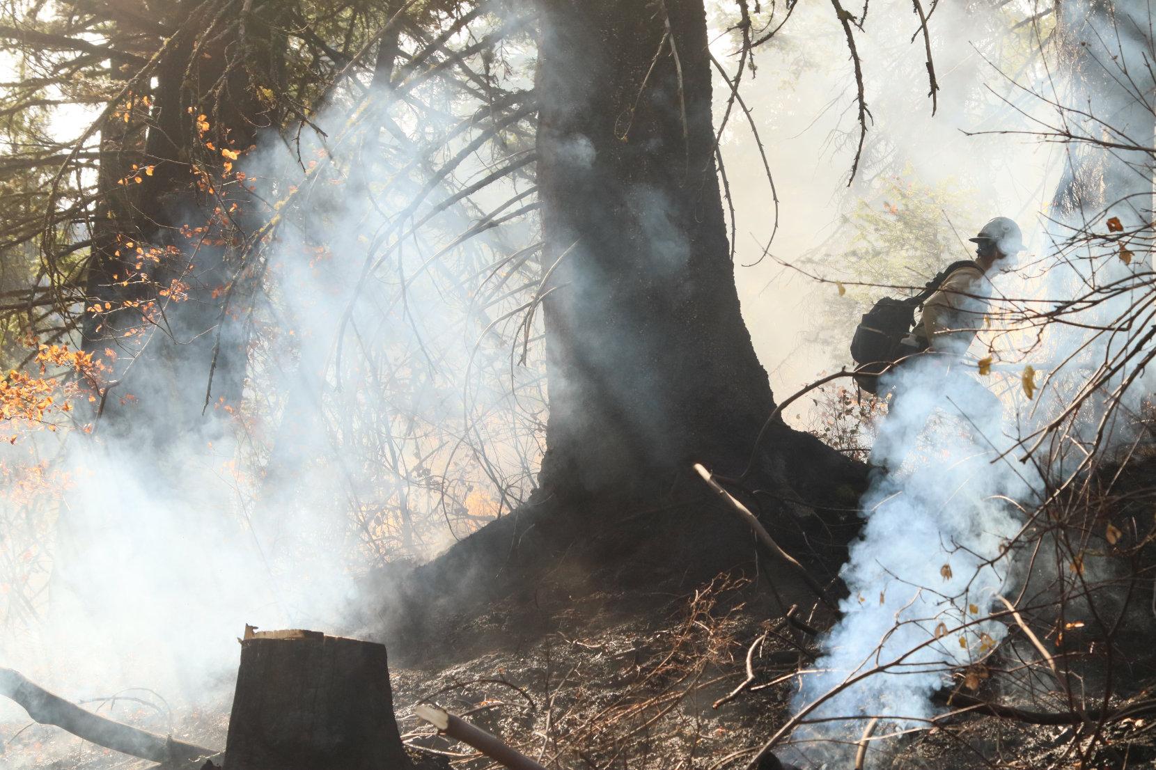 Firefighter Hikes Through Smoke