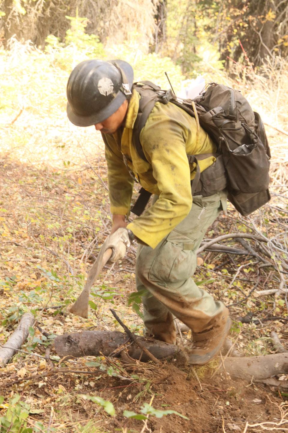 Firefighter Digs with Pulaski Tool