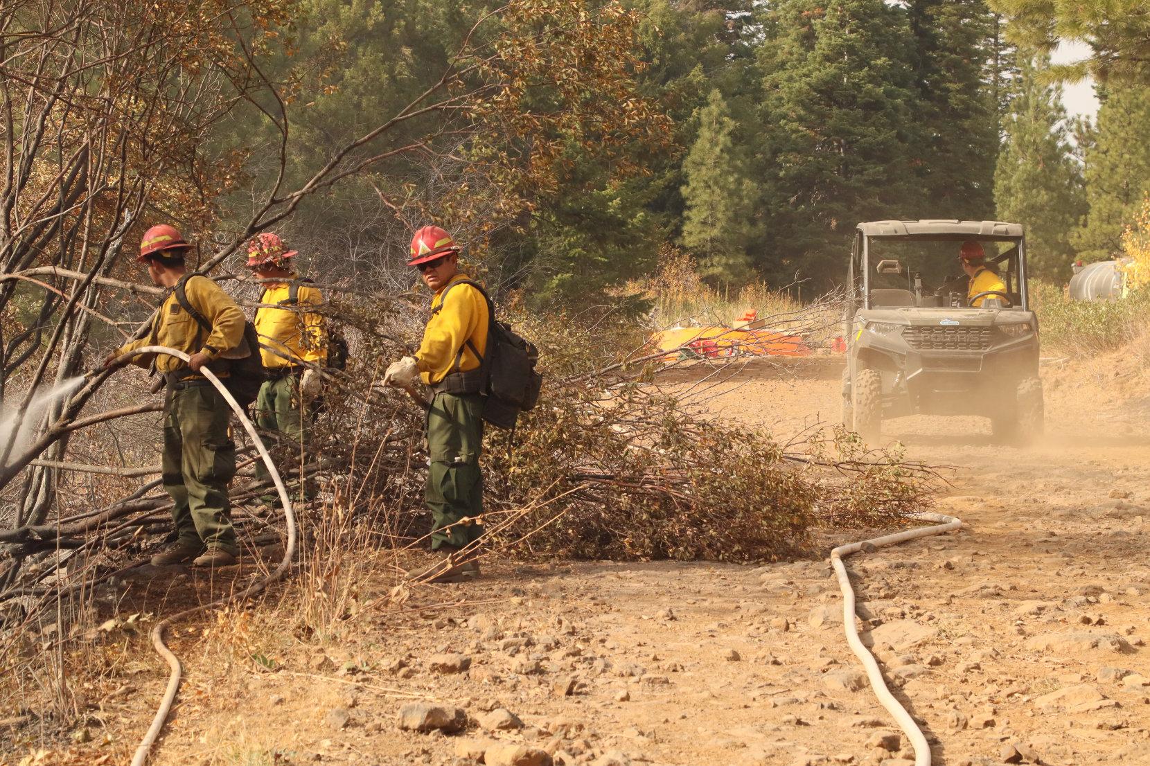 Firefighters Along Road with Hose