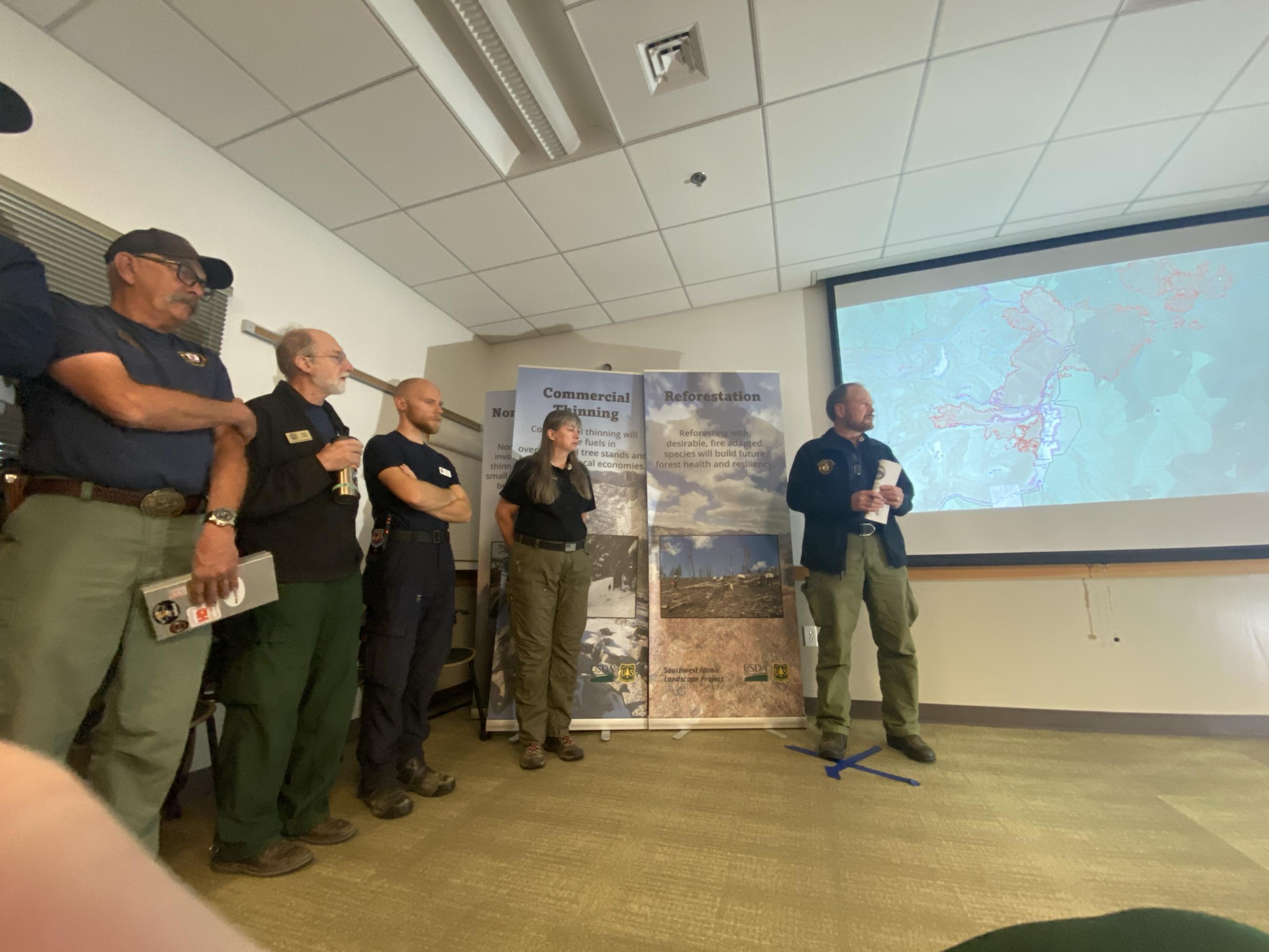 Morning briefing at Logan Fire ICP - IMT line up with Incident Commander