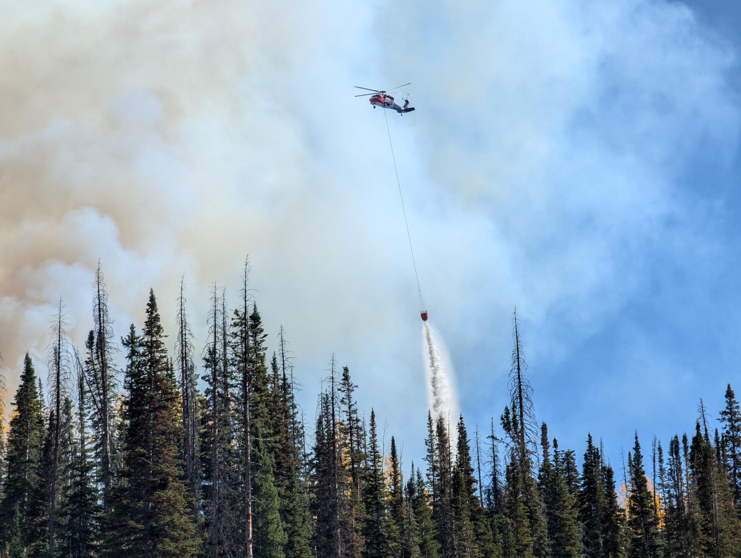 Type 1 Helicopter Performing Bucket Drops of water on the Yellow Lake Fire
