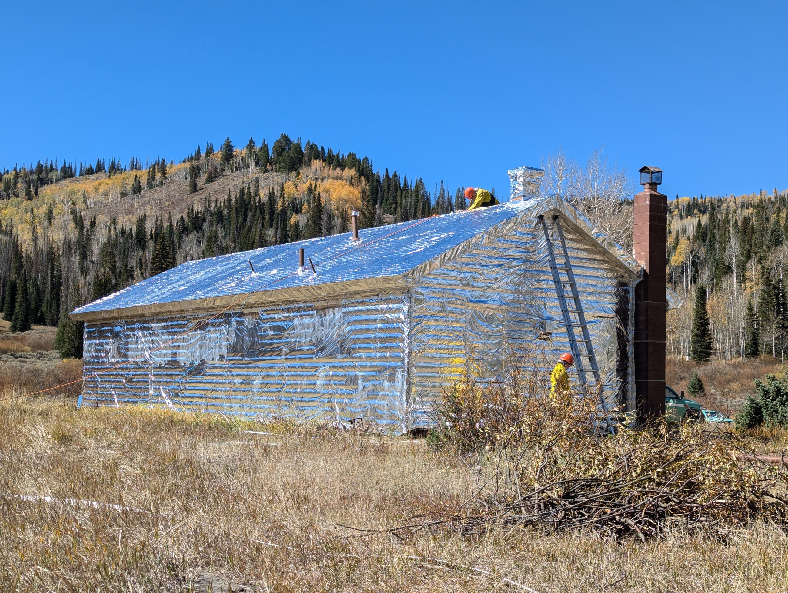 Historic Mill Hollow Ranger Station wrapped with heat reflective metal sheeting. 