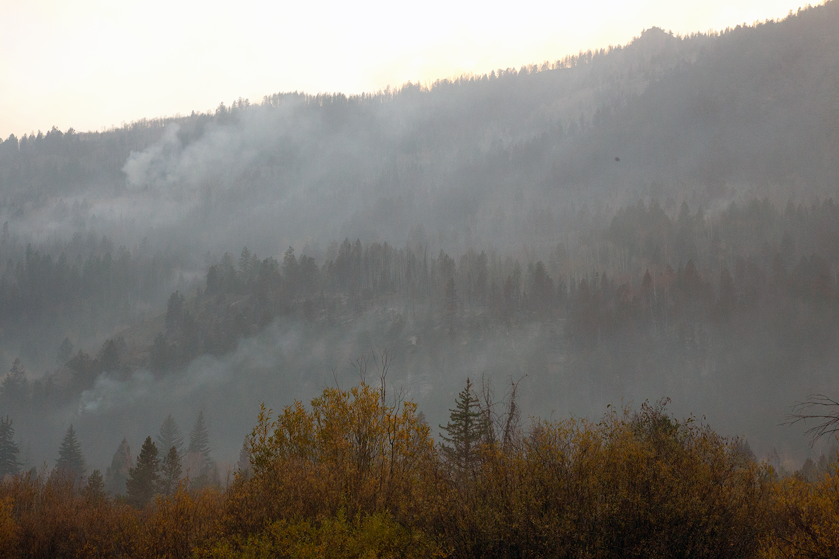 Smoke visible on a mountain side.