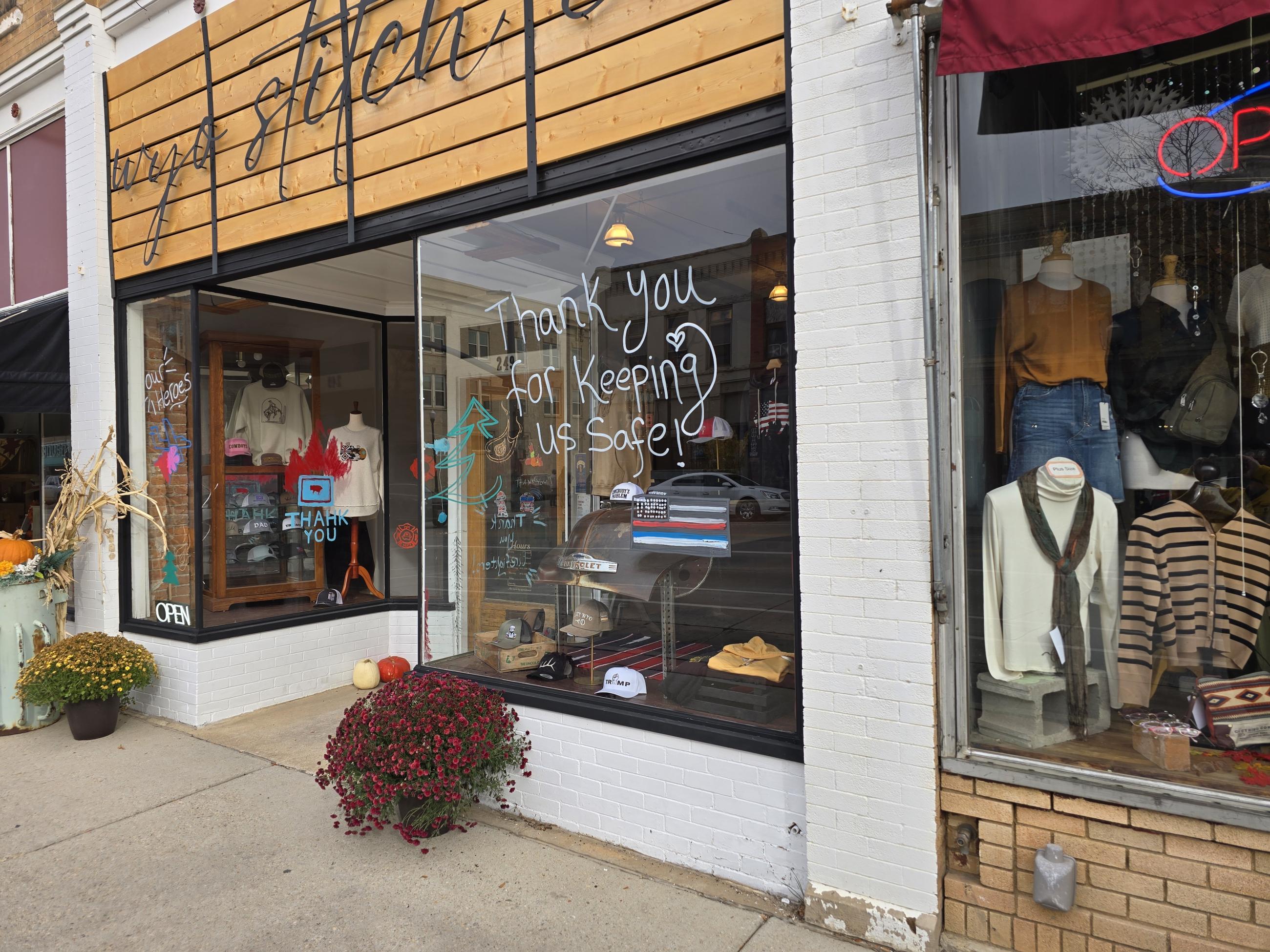 a store writes thanks on their window