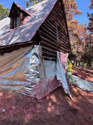 firefighters remove protective wrap from remote cabins on oct 25
