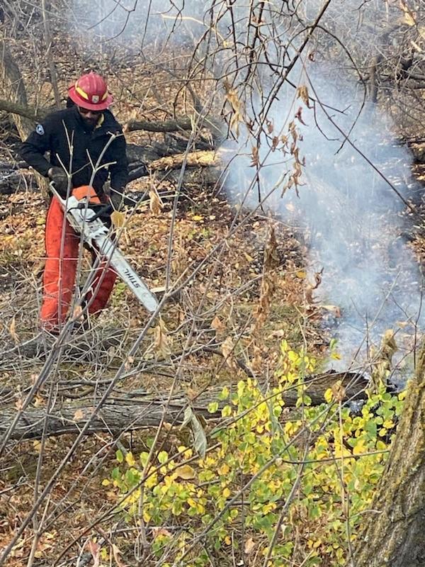 Firefighter operating a chainsaw