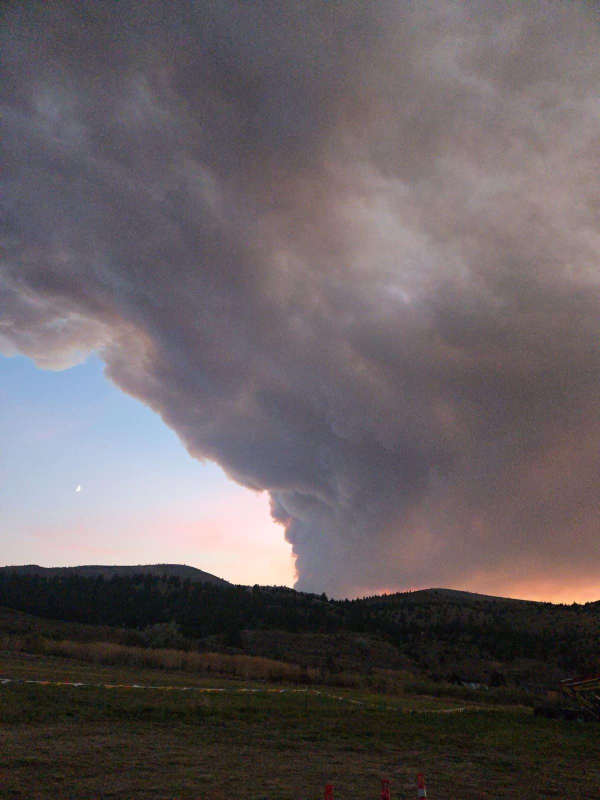 The moon is highlighted by a large smoke column from the Rail Ridge Fire with portions of ICP in the foreground