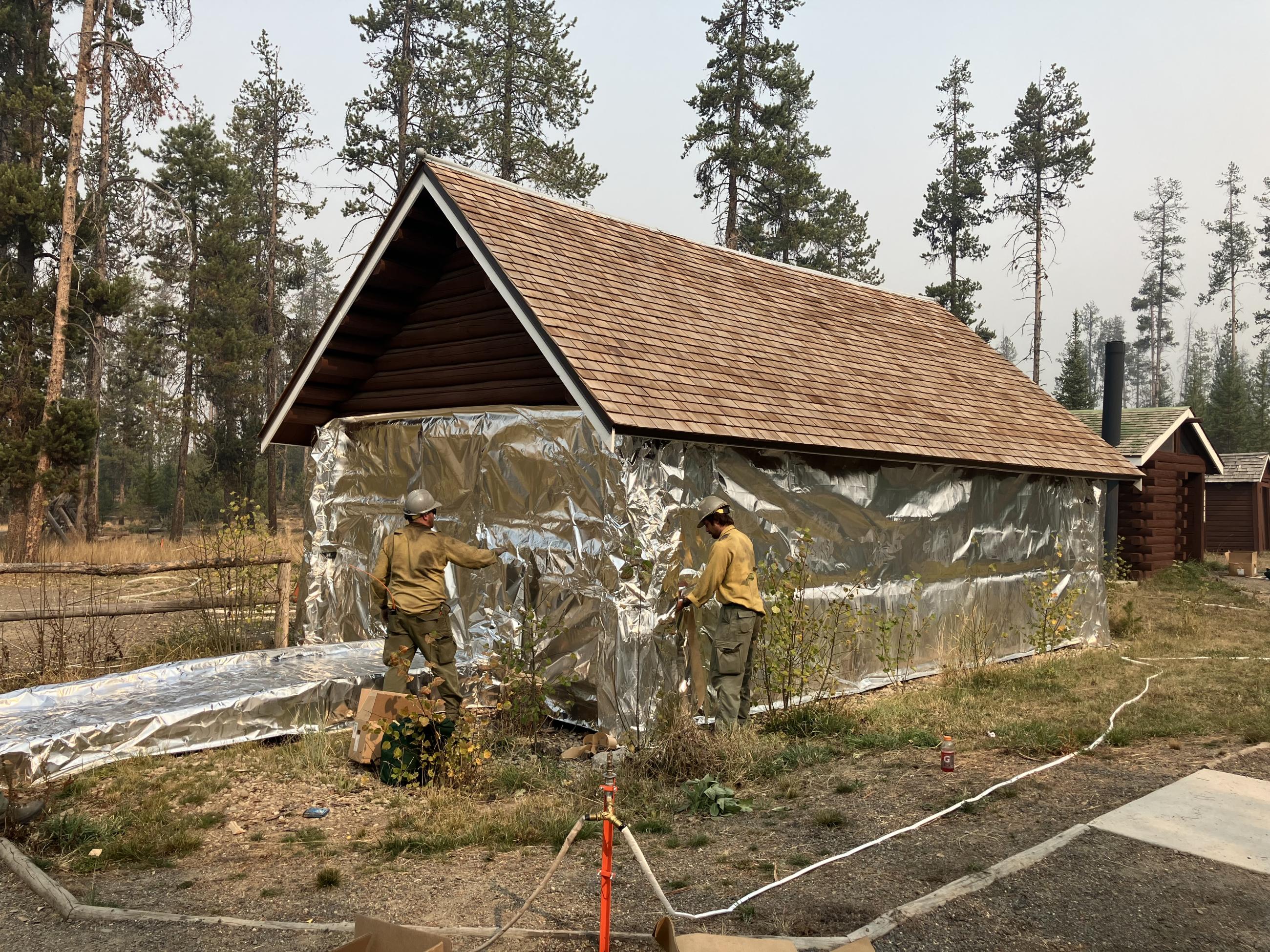 Image showing Stolle Meadows Structure Getting Wrapped for Fire Suppression Protection