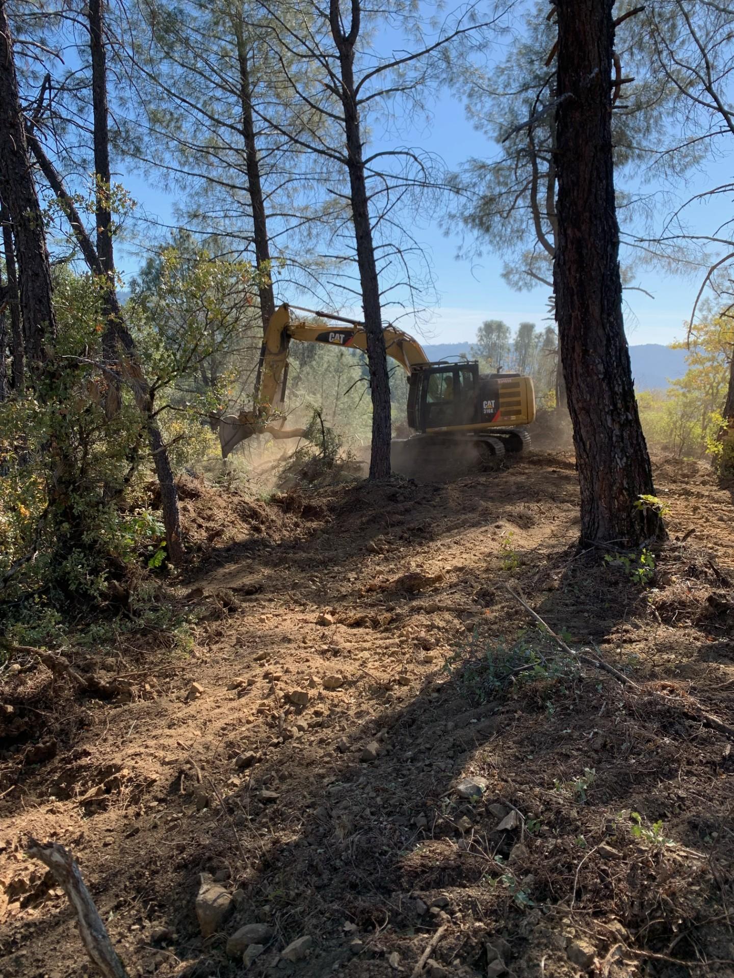 An excavator performing fire suppression repair