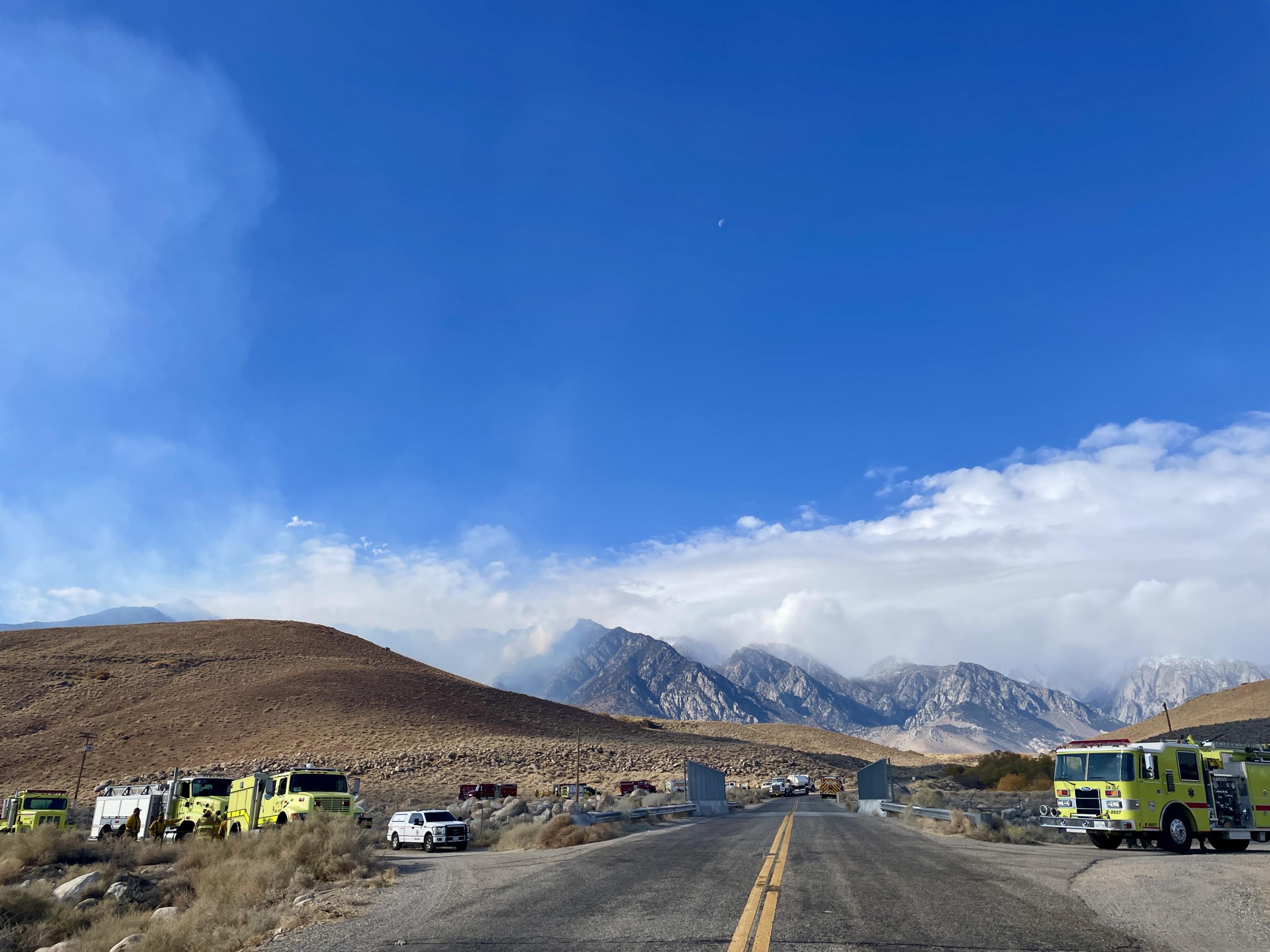 sky, clouds, smoke, road, mountains, fire trucks