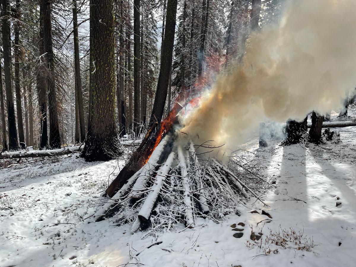 pile burning in snowy winter conditions 