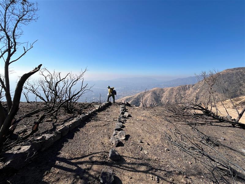 Color Image Showing BAER Archeologist David Peebles assesses Historic Mount Lowe Railway above City of Altadena in the Eaton Burned Area