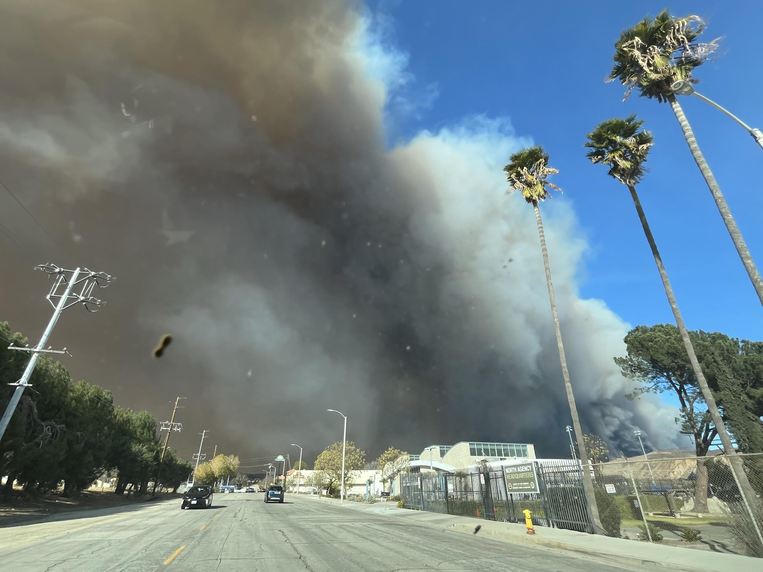 Showing black smoke column from Hughes Fire