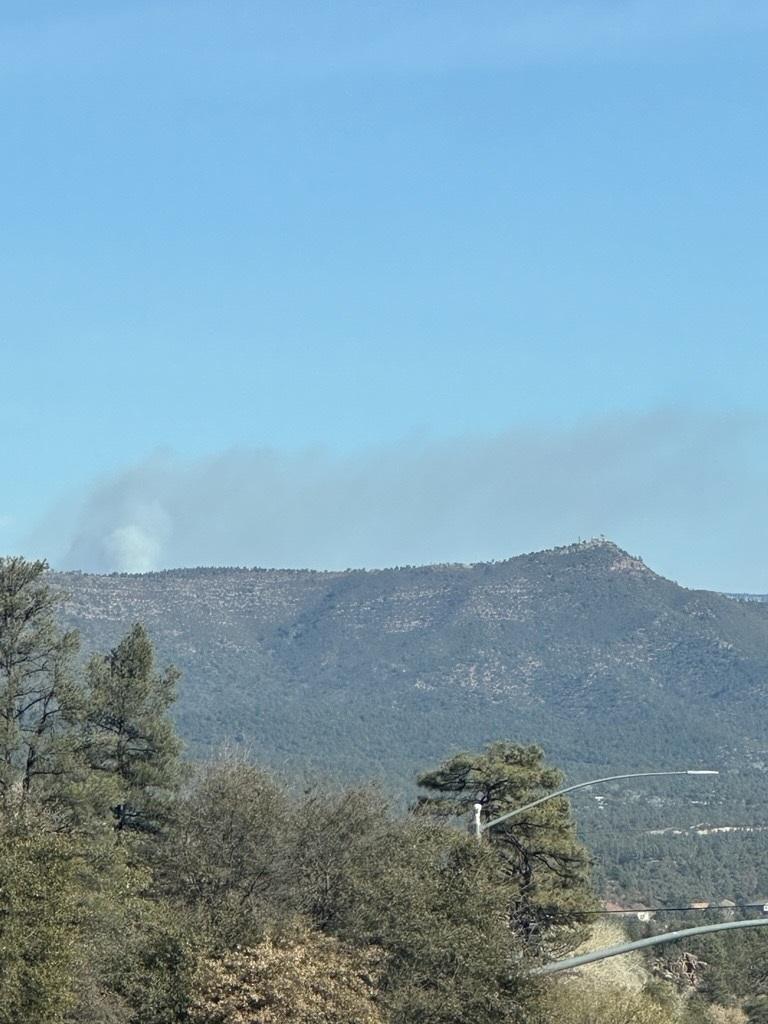 Smoke drifting from a ridgeline in the distance.