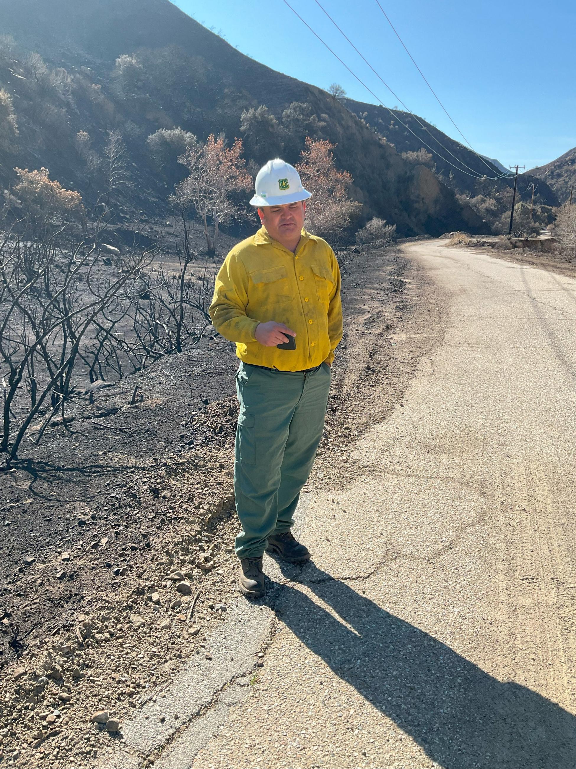 Photo Image Showing BAER Road Engineer Pablo Gonzales Evaluates Road Conditions in the Hughes Burn Area